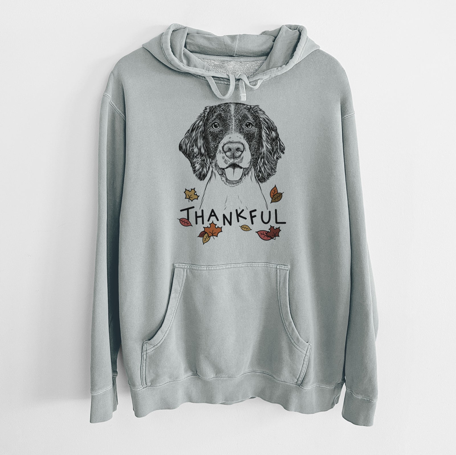 Hand-drawn sketch of Ever the English Springer Spaniel with 'Thankful' lettering and autumn leaves on a Sage Unisex pigment dyed hoodie
