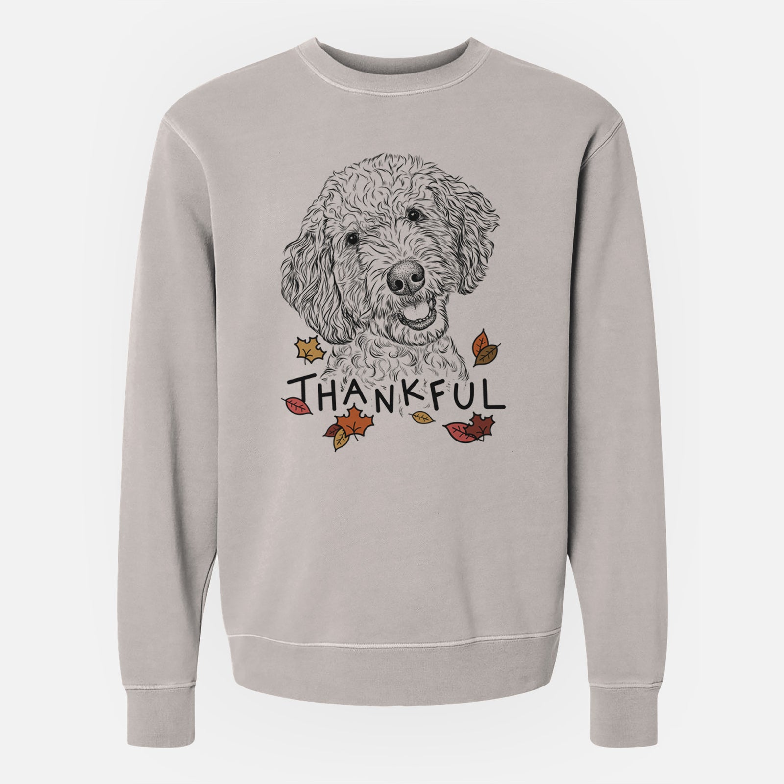 Hand-drawn sketch of Gizmo the Goldendoodle with 'Thankful' lettering and autumn leaves on a Cement Unisex pigment dyed crew sweatshirt