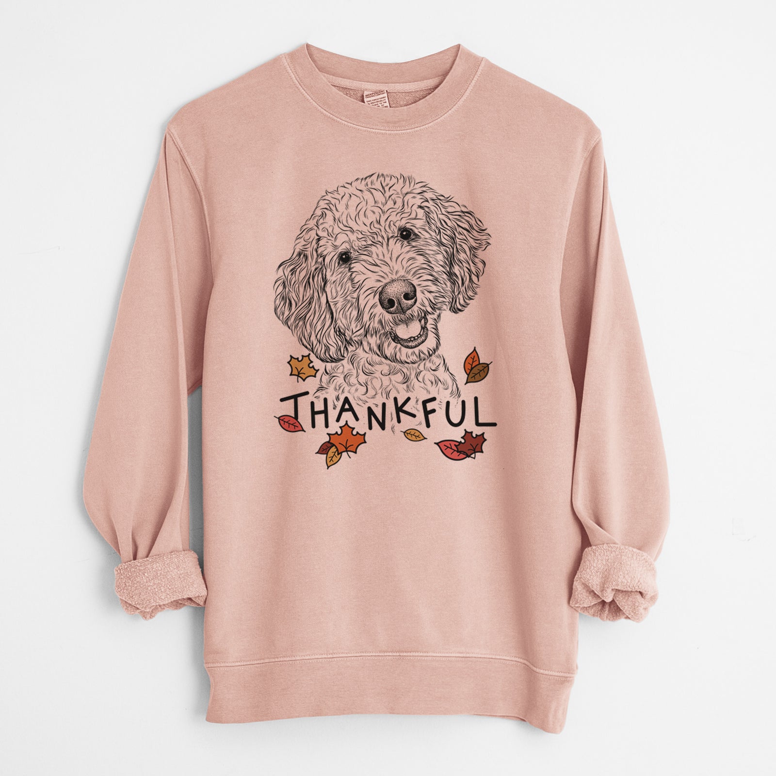Hand-drawn sketch of Gizmo the Goldendoodle with 'Thankful' lettering and autumn leaves on a Dusty Pink Unisex pigment dyed crew sweatshirt