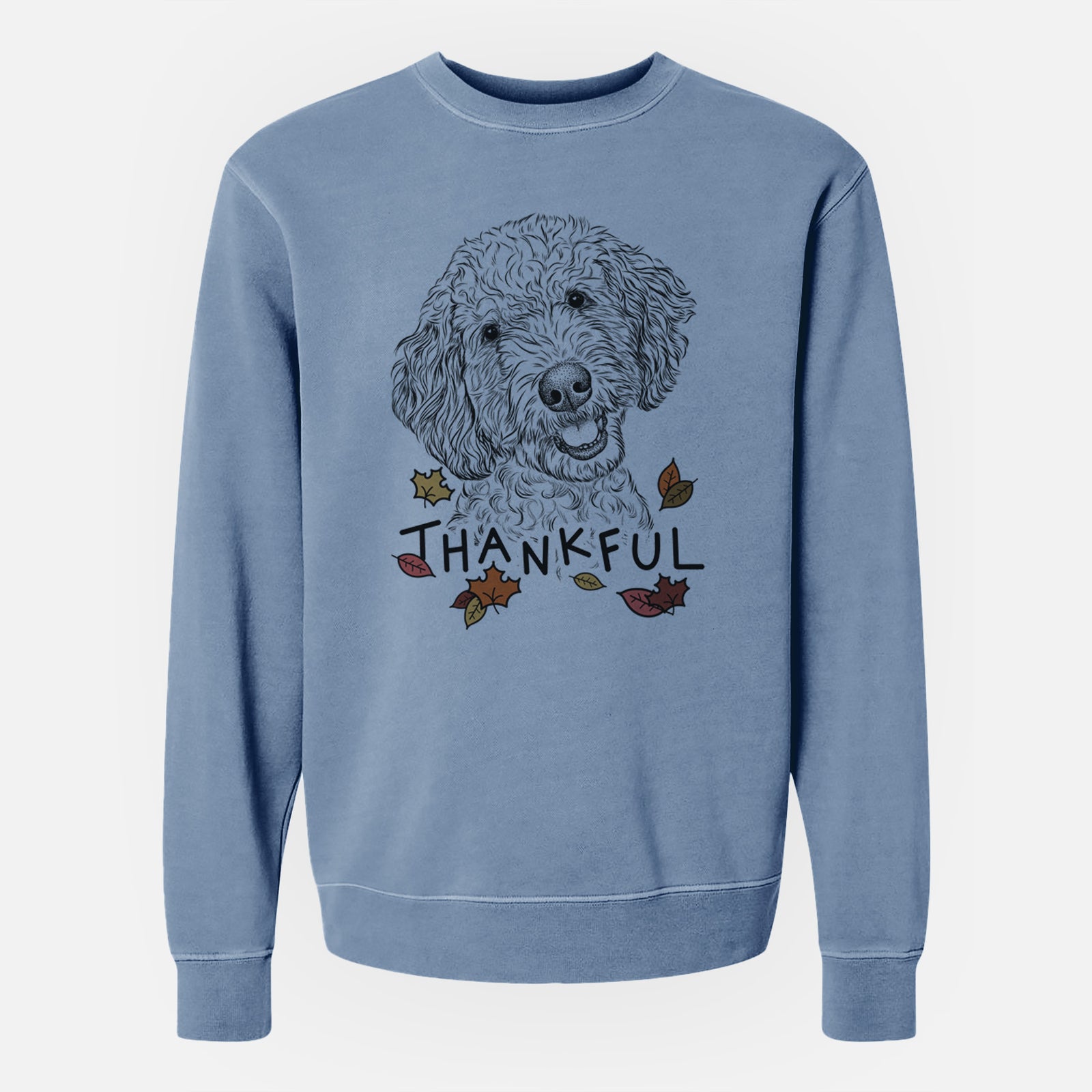 Hand-drawn sketch of Gizmo the Goldendoodle with 'Thankful' lettering and autumn leaves on a Slate Blue Unisex pigment dyed crew sweatshirt