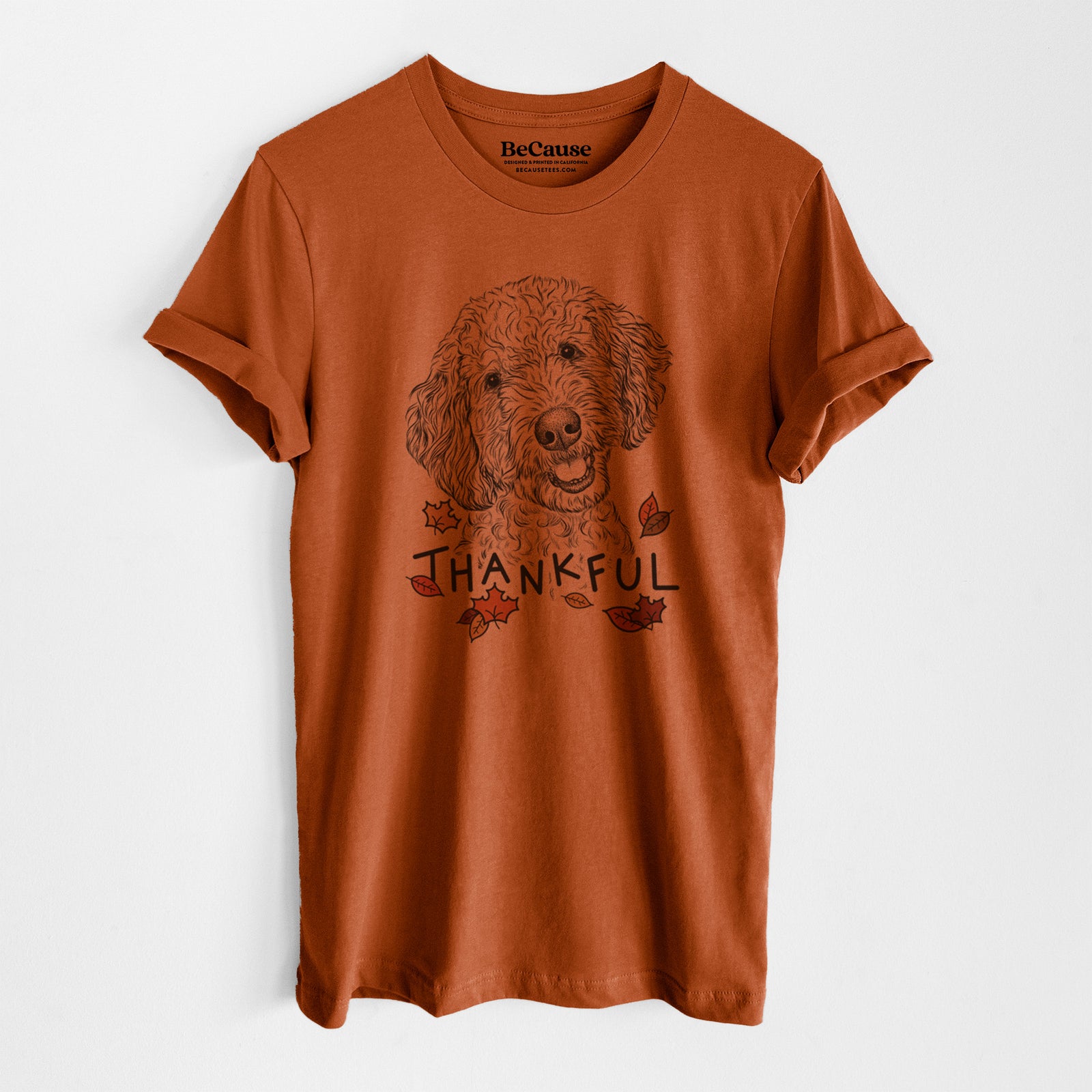 Hand-drawn sketch of Gizmo the Goldendoodle with 'Thankful' lettering and autumn leaves on an Autumn Unisex crewneck, worn by a model