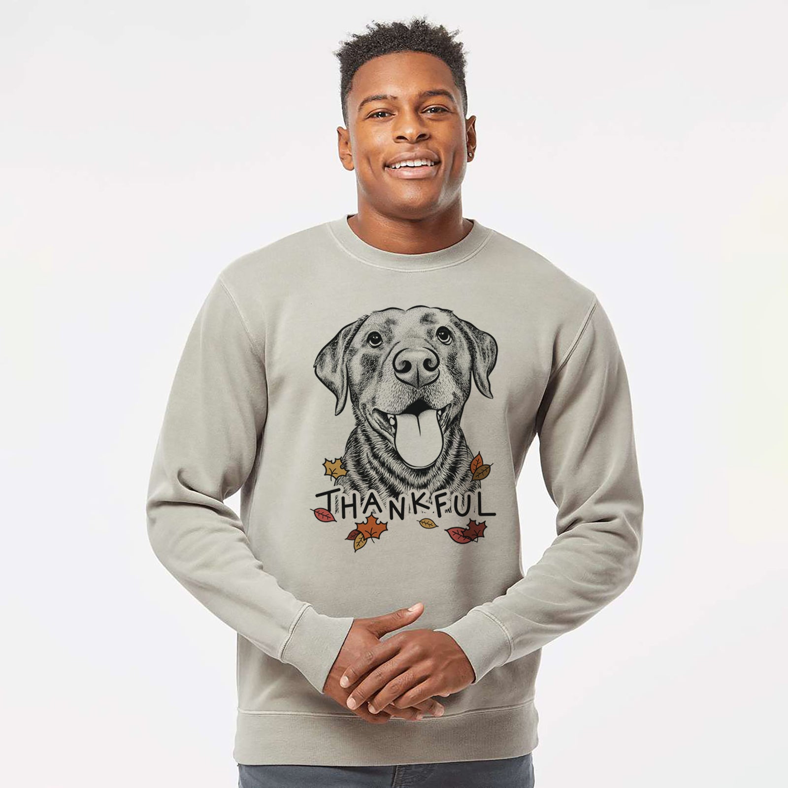 Hand-drawn sketch of Gwen the Labrador Retriever with 'Thankful' lettering and autumn leaves on a Cement Unisex pigment dyed crew sweatshirt