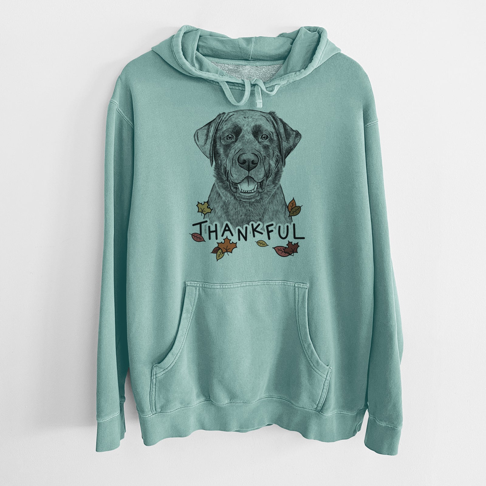 Hand-drawn sketch of Heath the Black Lab with 'Thankful' lettering and autumn leaves on a Mint Unisex pigment dyed hoodie