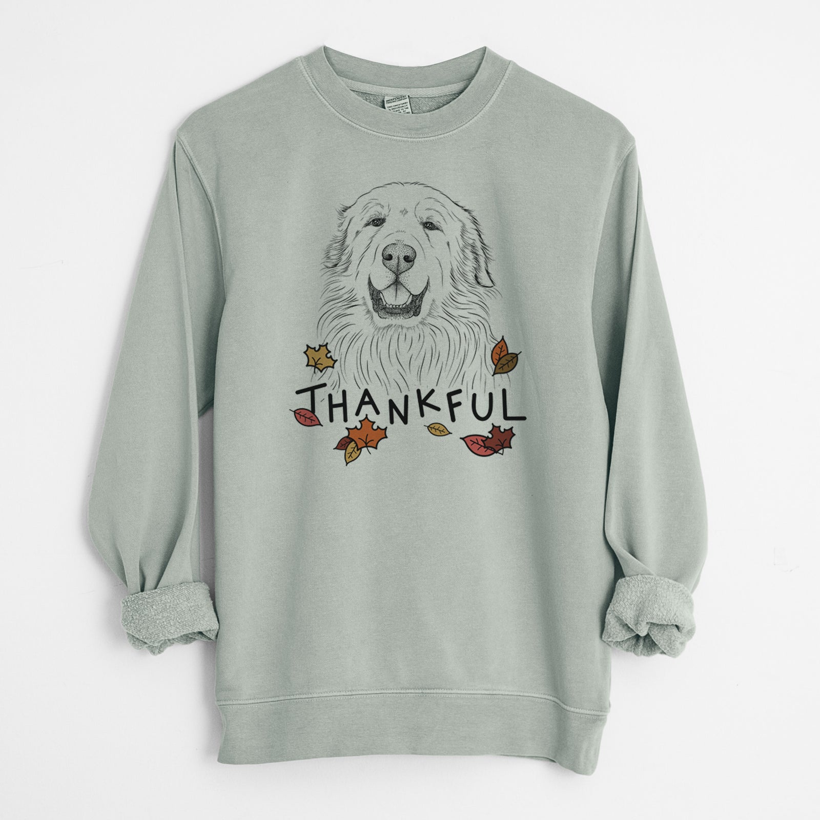 Hand-drawn sketch of Horton the Great Pyrenees with 'Thankful' lettering and autumn leaves on a Sage Unisex pigment dyed crew sweatshirt