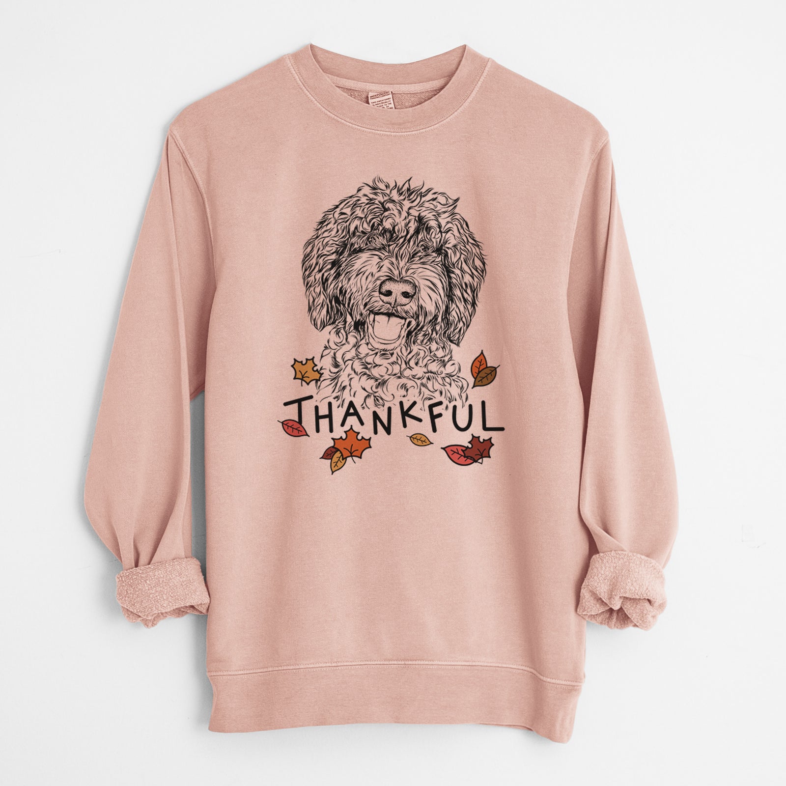 Hand-drawn sketch of Jack the Chocolate Labradoodle with 'Thankful' lettering and autumn leaves on a Dusty Pink Unisex pigment dyed crew sweatshirt