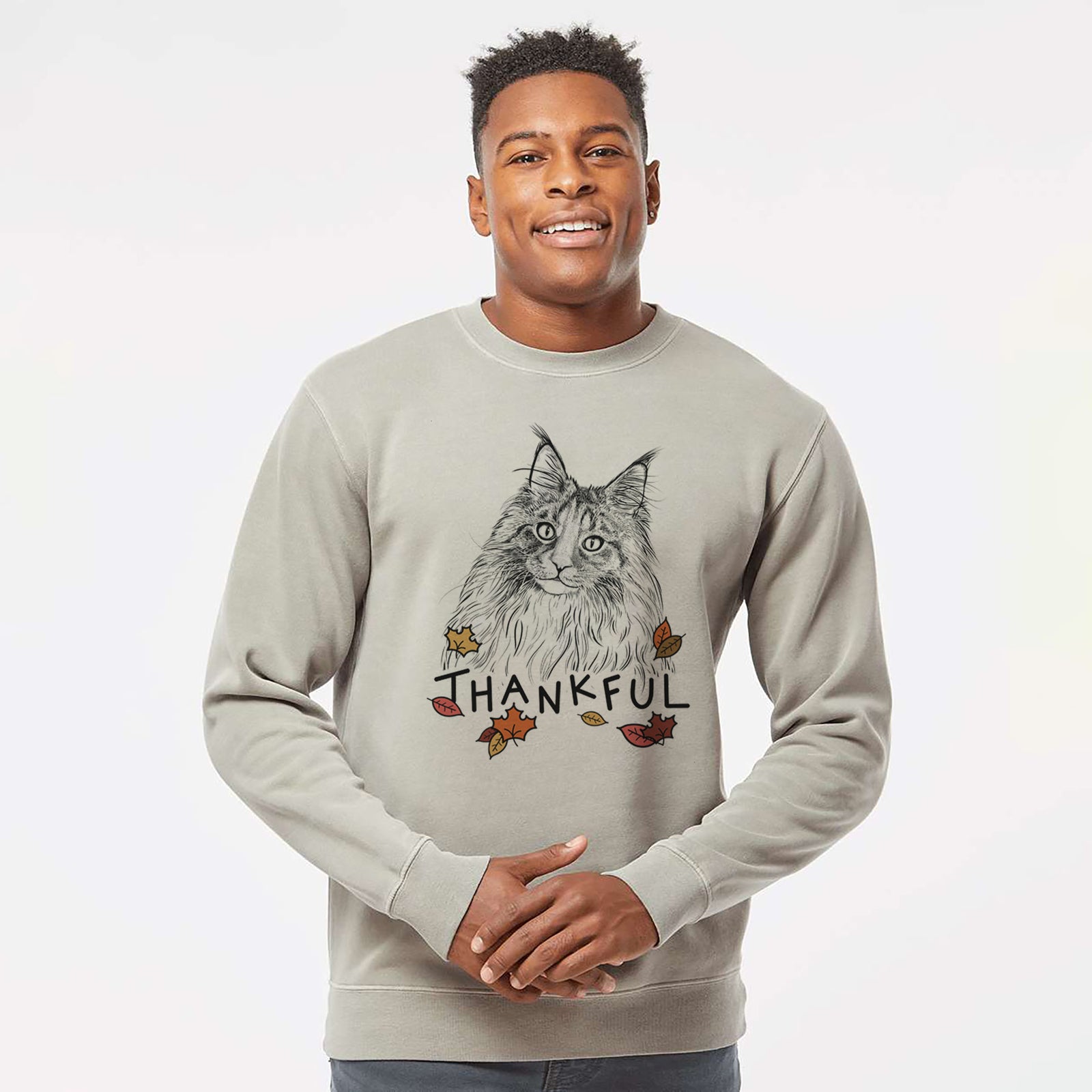 Hand-drawn sketch of Kiki the Maine Coon Cat with 'Thankful' lettering and autumn leaves on a Cement Unisex pigment dyed crew sweatshirt