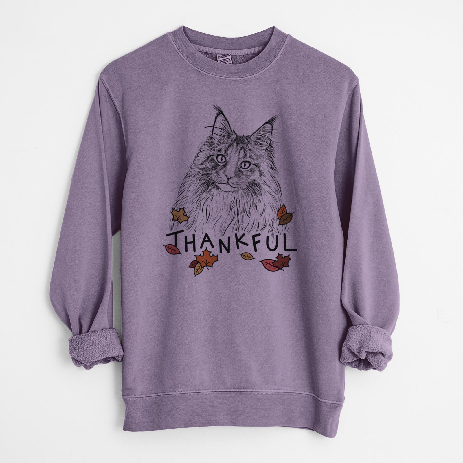 Hand-drawn sketch of Kiki the Maine Coon Cat with 'Thankful' lettering and autumn leaves on a Plum Unisex pigment dyed crew sweatshirt