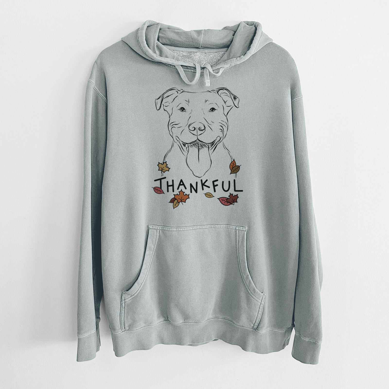 Hand-drawn sketch of Major the Pitbull with 'Thankful' lettering and autumn leaves on a Sage Unisex pigment dyed hoodie