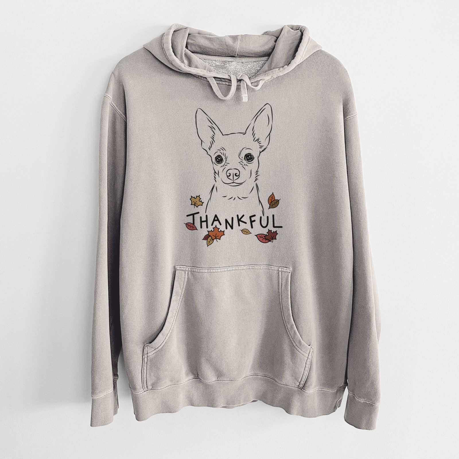 Hand-drawn sketch of Martini the Chihuahua with 'Thankful' lettering and autumn leaves on a Cement Unisex pigment dyed hoodie
