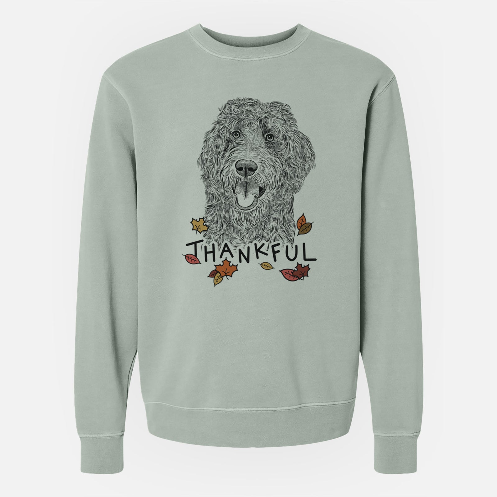 Hand-drawn sketch of Murr Dog the Labradoodle with 'Thankful' lettering and autumn leaves on a Sage Unisex pigment dyed crew sweatshirt