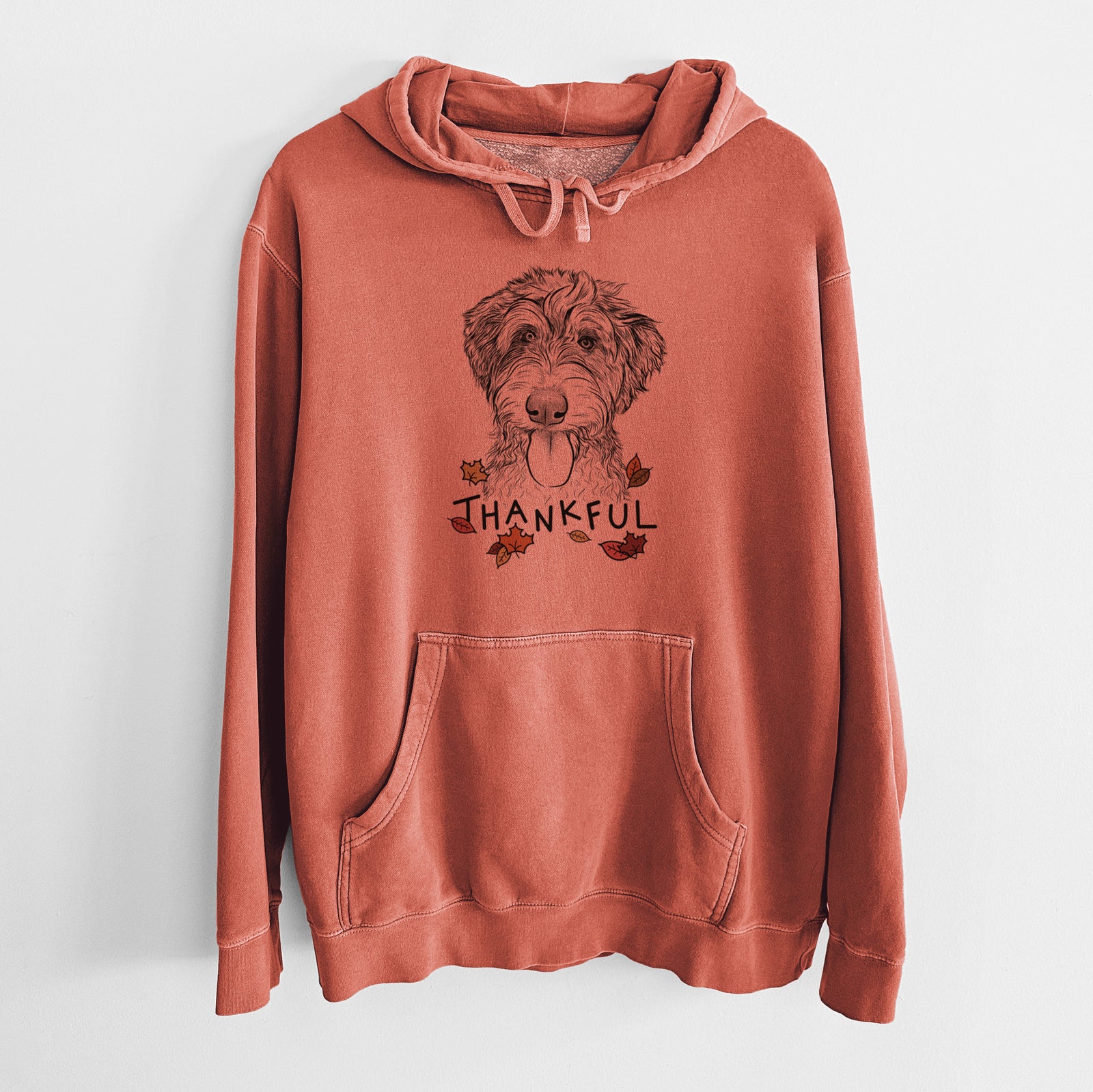 Hand-drawn sketch of Myrtle Mae the Aussiedoodle with 'Thankful' lettering and autumn leaves on an Amber Unisex pigment dyed hoodie
