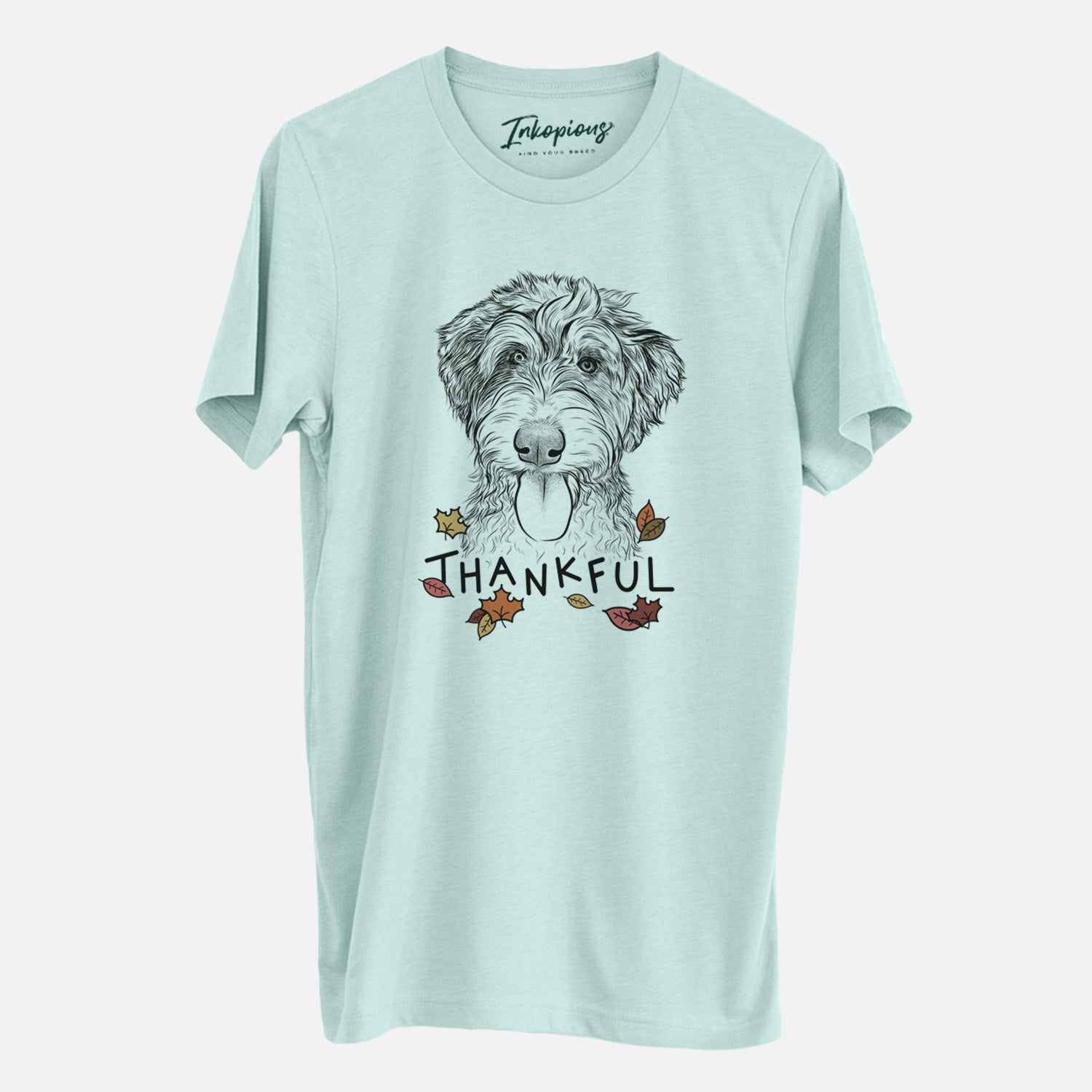 Hand-drawn sketch of Myrtle Mae the Aussiedoodle with 'Thankful' lettering and autumn leaves on a Heather Sage Unisex crewneck
