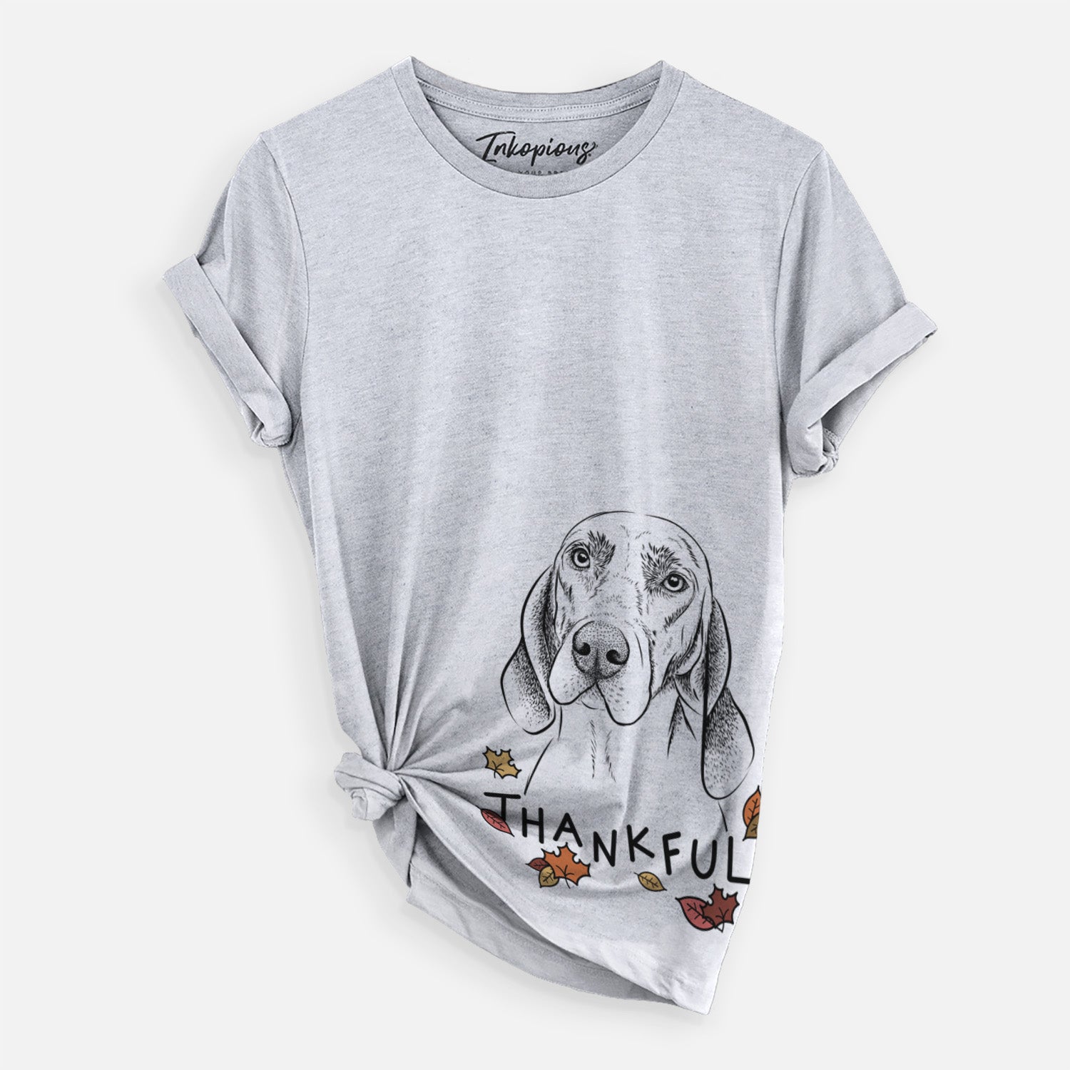 Hand-drawn sketch of Norman the Plott Hound with 'Thankful' lettering and autumn leaves on a Grey Unisex crewneck, worn by a woman