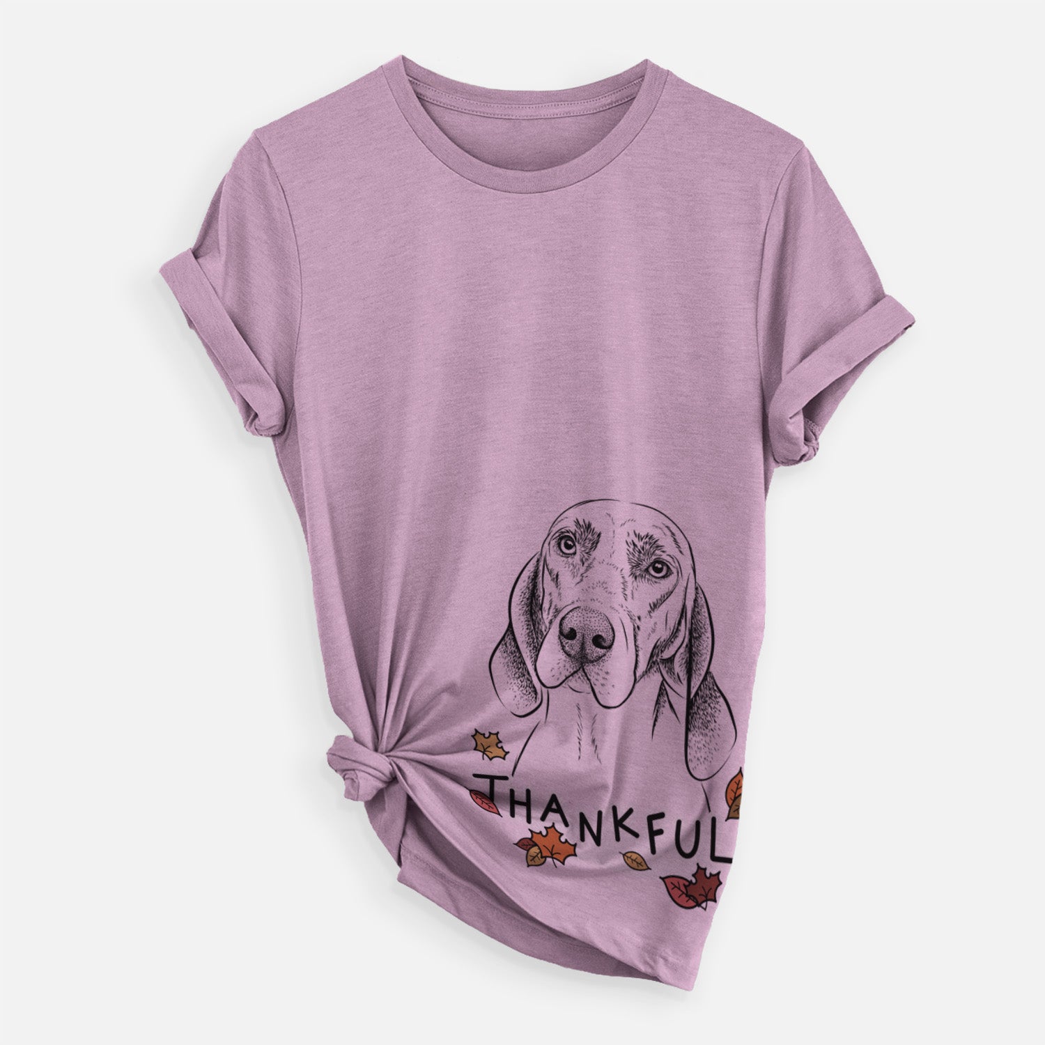 Hand-drawn sketch of Norman the Plott Hound with 'Thankful' lettering and autumn leaves on an Orchid Unisex crewneck, worn by a woman