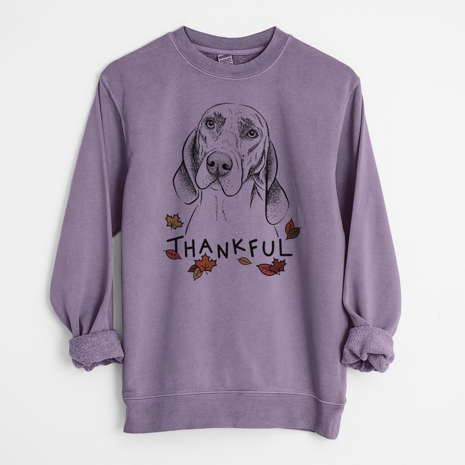 Hand-drawn sketch of Norman the Plott Hound with 'Thankful' lettering and autumn leaves on a Plum Unisex pigment dyed crew sweatshirt