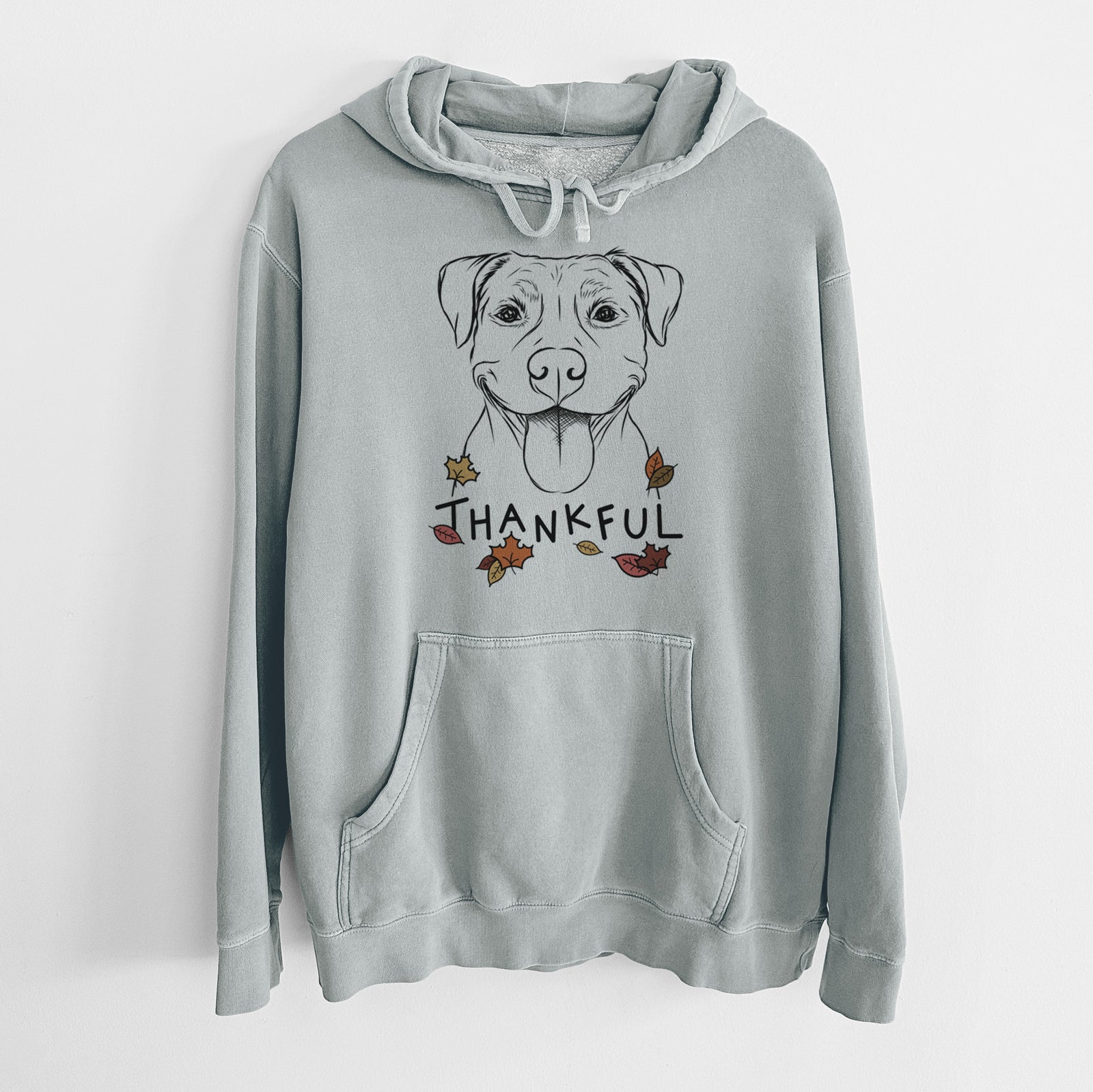 Hand-drawn sketch of Parker the Pitbull with 'Thankful' lettering and autumn leaves on a Sage Unisex pigment dyed hoodie