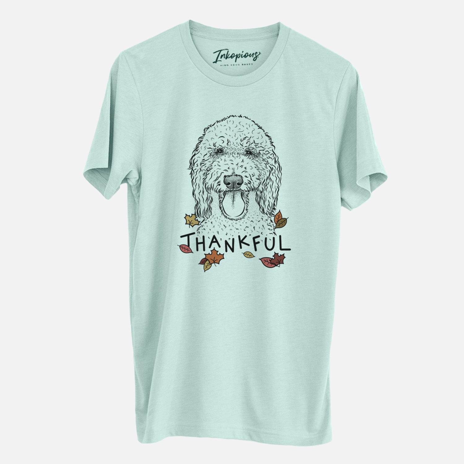Hand-drawn sketch of Pavlov the Goldendoodle with 'Thankful' lettering and autumn leaves on a Heather Sage Unisex crewneck