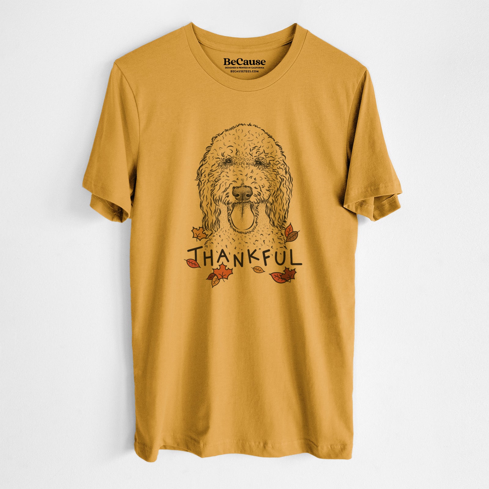 Hand-drawn sketch of Pavlov the Goldendoodle with 'Thankful' lettering and autumn leaves on a Mustard Unisex crewneck, worn by a man