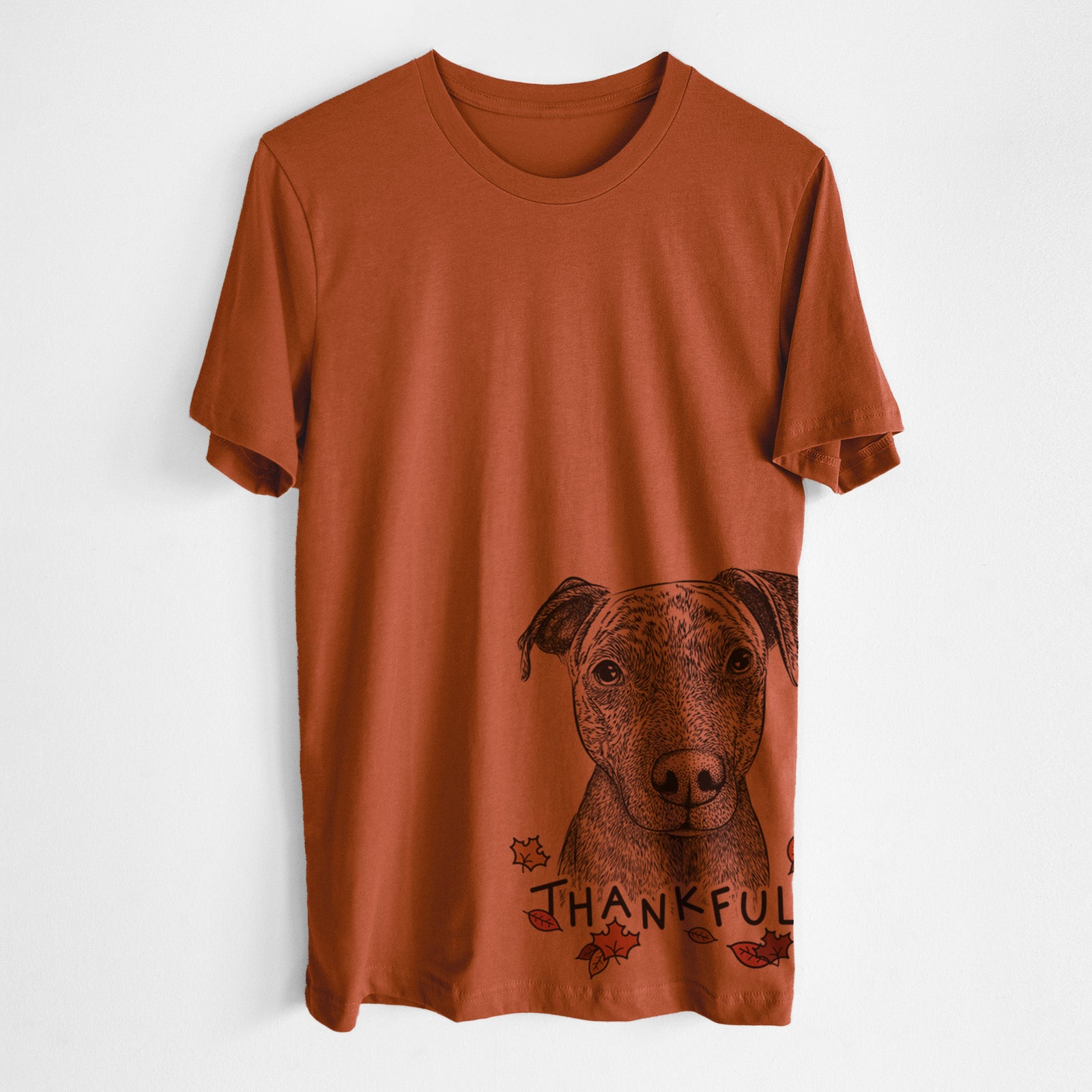 Hand-drawn sketch of Reeses the Pitbull with 'Thankful' lettering and autumn leaves on an Autumn Unisex crewneck, worn by a man