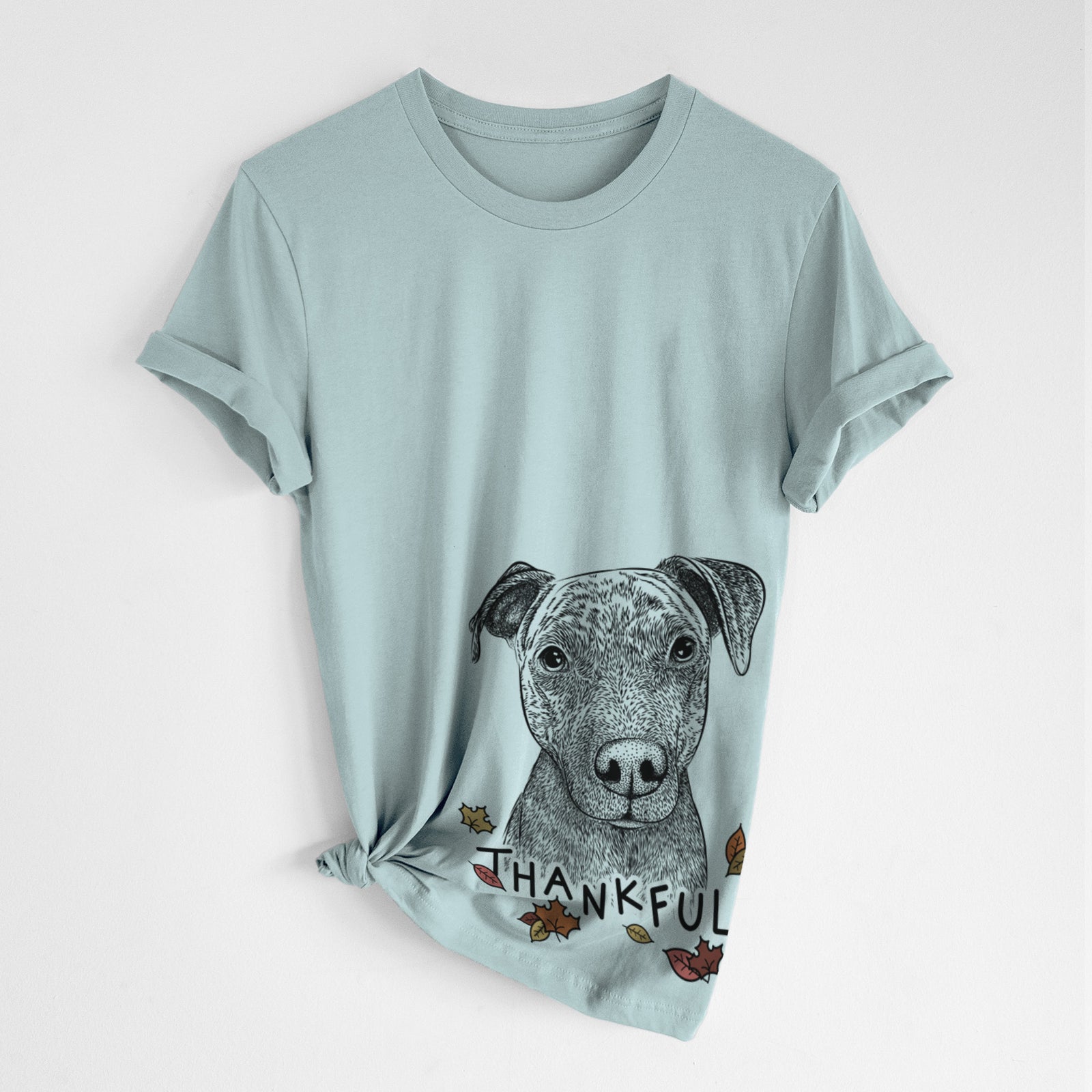 Hand-drawn sketch of Reeses the Pitbull with 'Thankful' lettering and autumn leaves on a Dusty Blue Unisex crewneck, worn by a woman