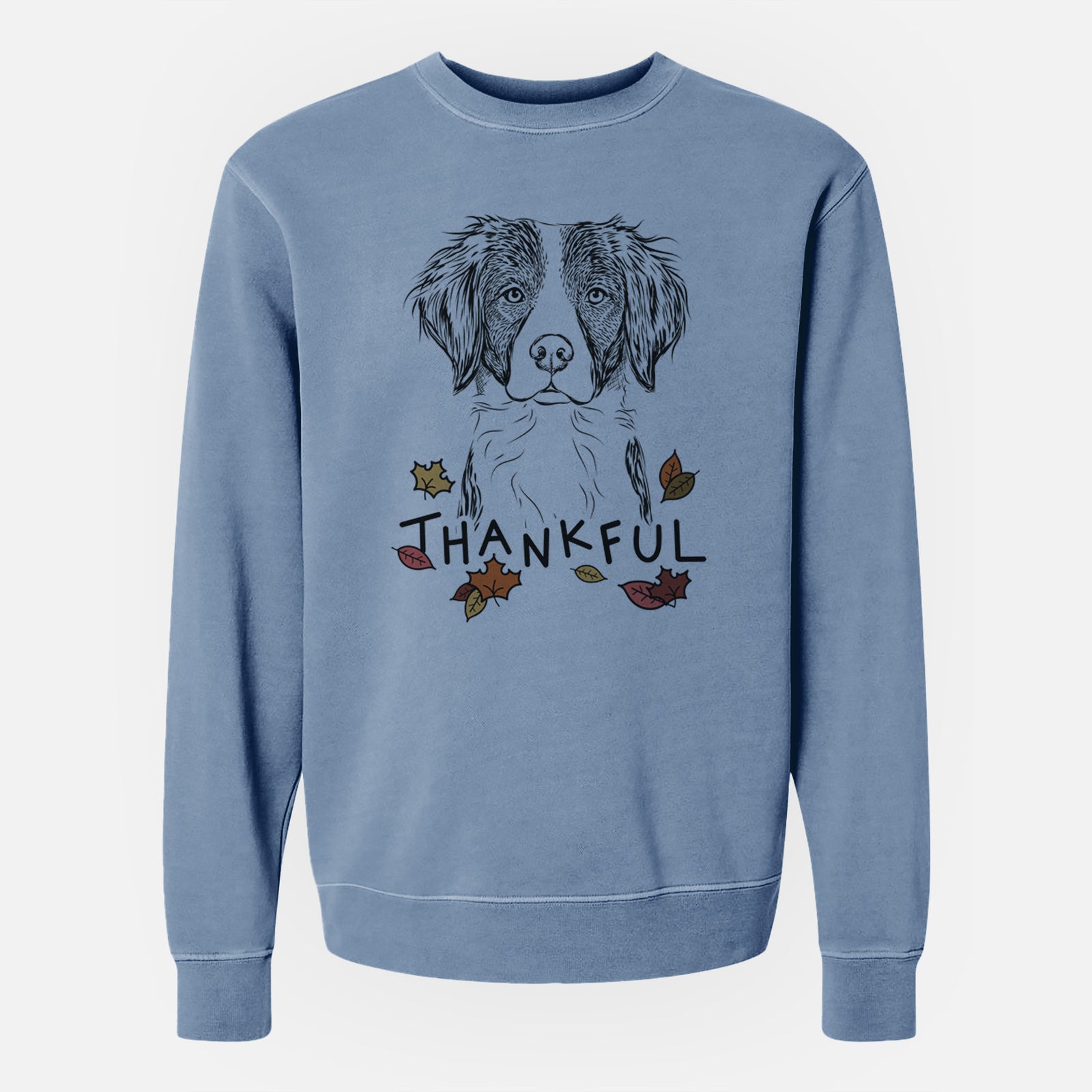 Hand-drawn sketch of Remi the Brittany with 'Thankful' lettering and autumn leaves on a Slate Blue Unisex pigment dyed crew sweatshirt