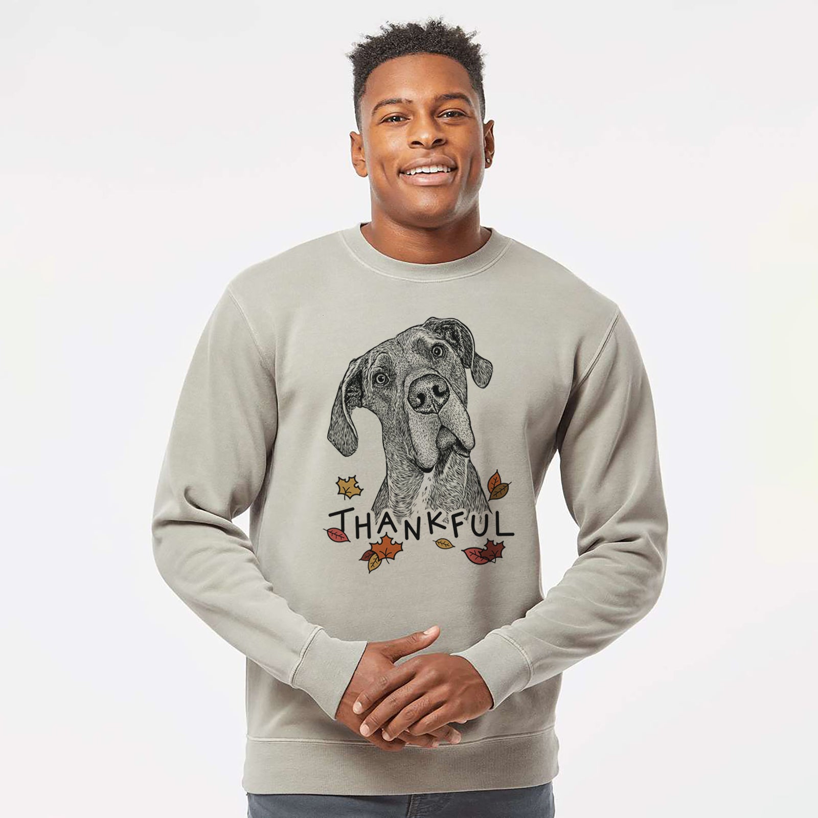 Hand-drawn sketch of River the Great Dane with 'Thankful' lettering and autumn leaves on a Cement Unisex pigment dyed crew sweatshirt