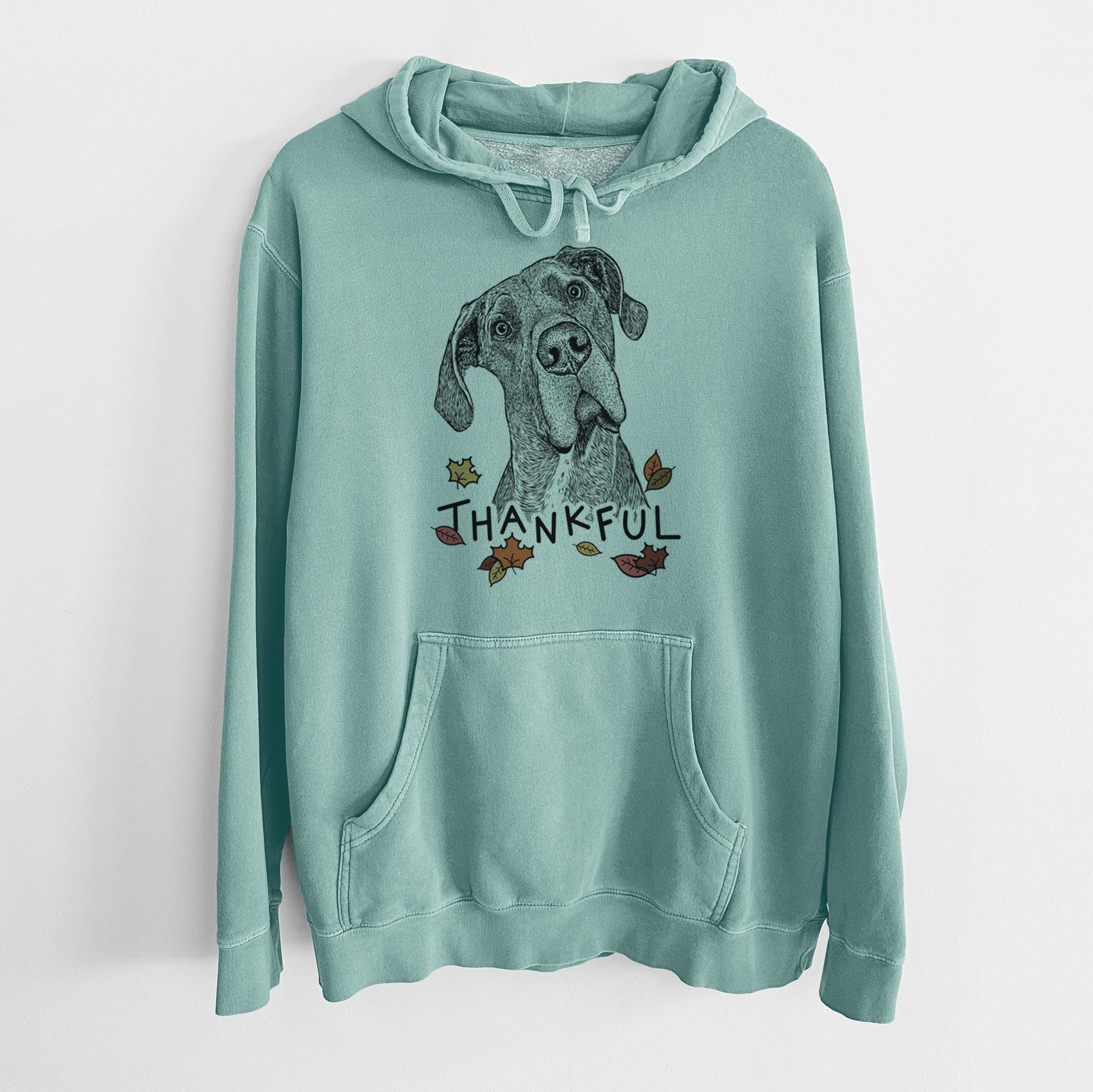 Hand-drawn sketch of River the Great Dane with 'Thankful' lettering and autumn leaves on a Mint Unisex pigment dyed hoodie