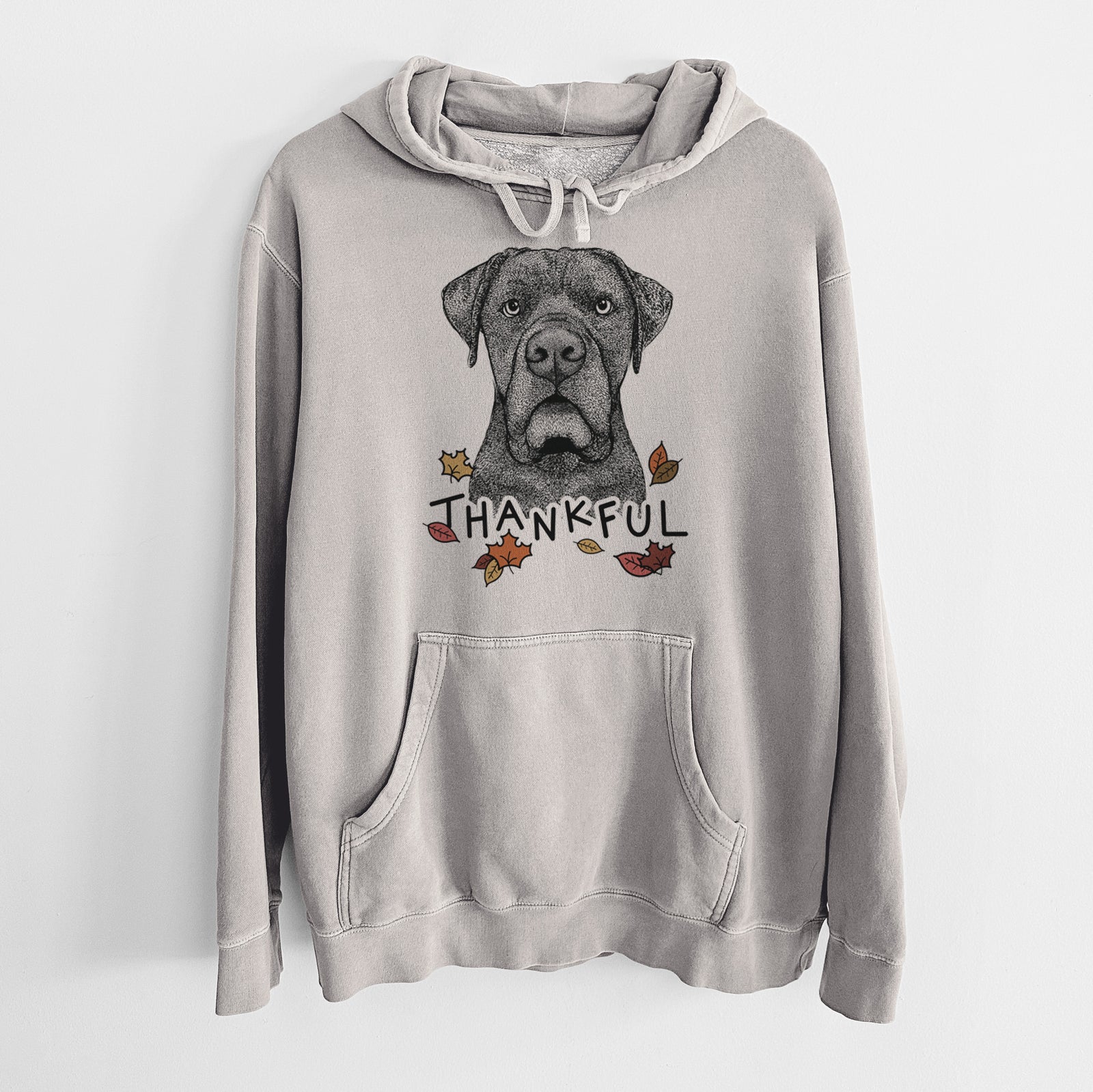 Hand-drawn sketch of Rocco the Cane Corso with 'Thankful' lettering and autumn leaves on a Cement Unisex pigment dyed hoodie