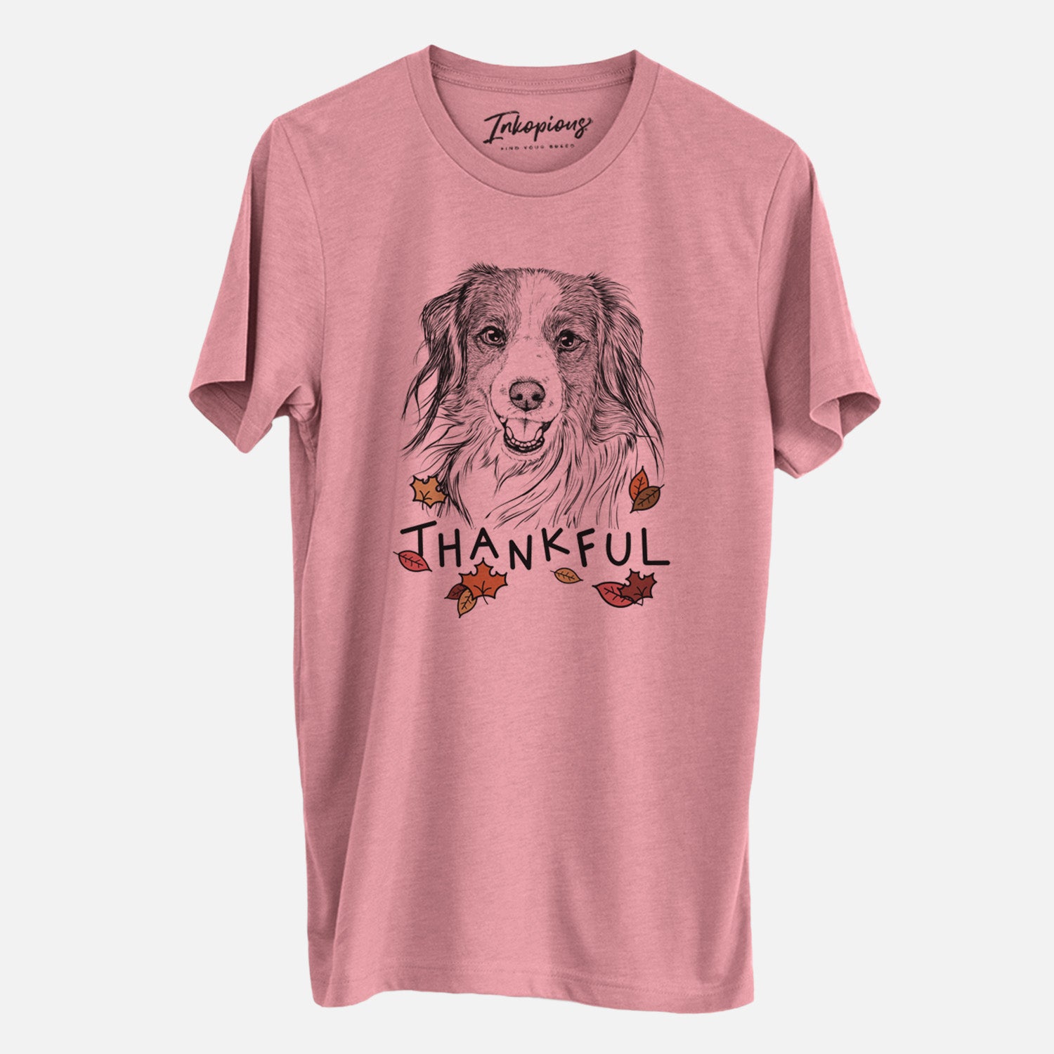 Hand-drawn sketch of Rutger the Nederlandse Kooikerhondje with 'Thankful' lettering and autumn leaves on a Mauve Unisex crewneck, worn by a man