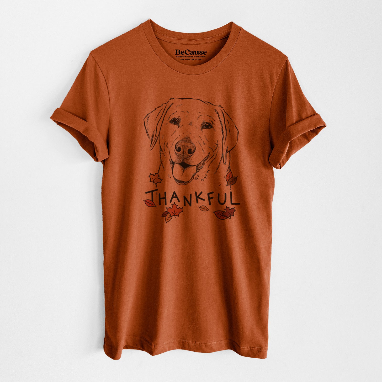 Hand-drawn sketch of Sanford the Labrador Retriever with 'Thankful' lettering and autumn leaves on an Autumn Unisex crewneck, worn by a model