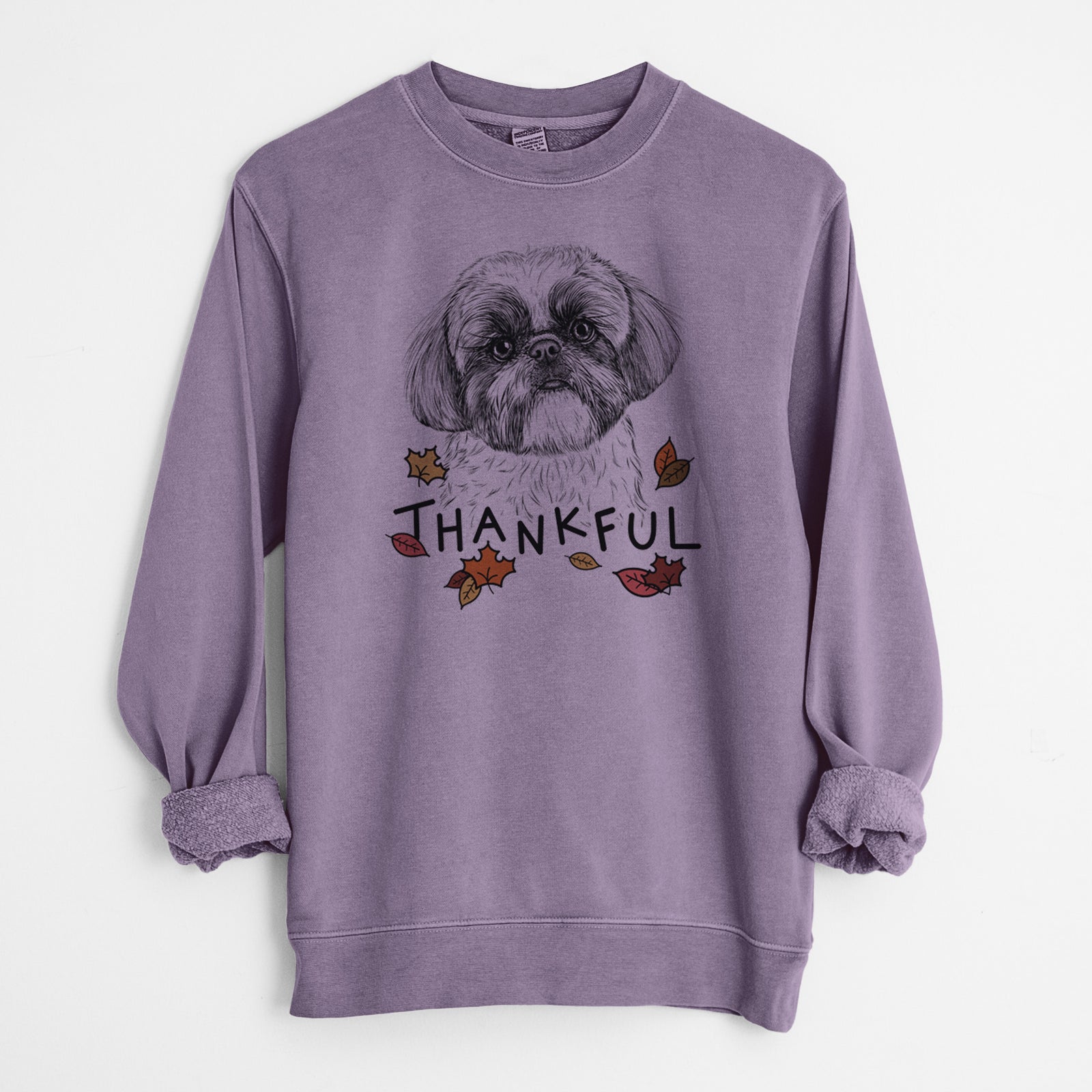 Hand-drawn sketch of Simon the Shih Tzu with 'Thankful' lettering and autumn leaves on a Plum Unisex pigment dyed crew sweatshirt