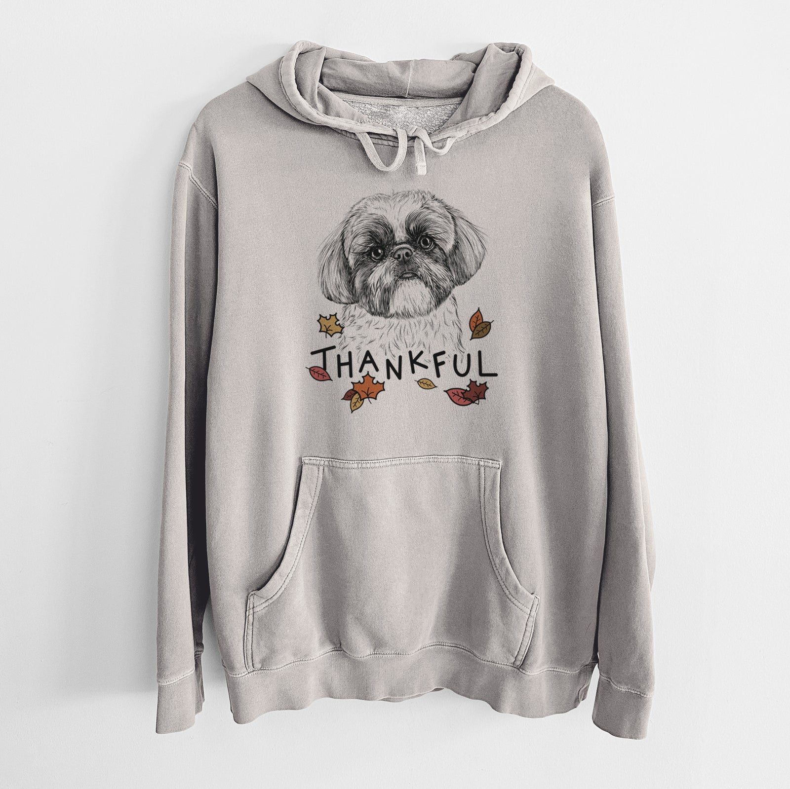 Hand-drawn sketch of Simon the Shih Tzu with 'Thankful' lettering and autumn leaves on a Cement Unisex pigment dyed hoodie