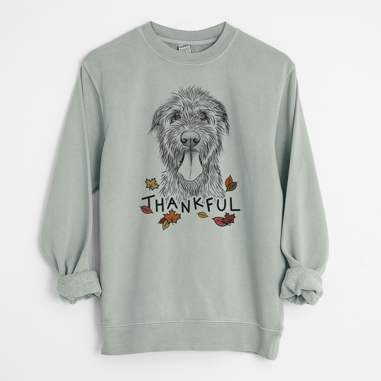 Hand-drawn sketch of Sullivan the Irish Wolfhound with 'Thankful' lettering and autumn leaves on a Sage Unisex pigment dyed crew sweatshirt