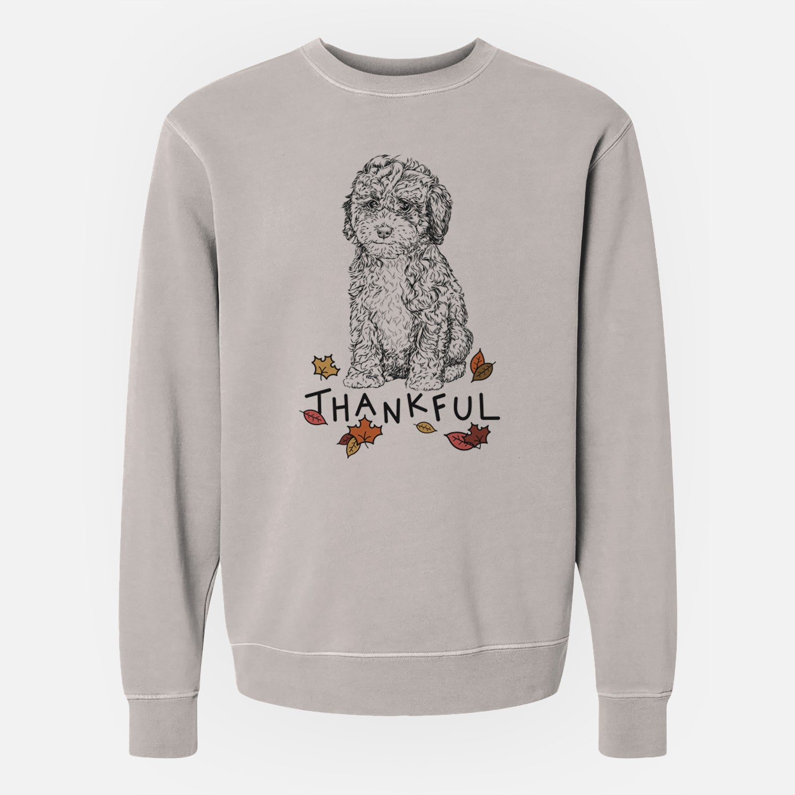 Hand-drawn sketch of Sweet Tea the Mini Doodle with 'Thankful' lettering and autumn leaves on a Cement Unisex pigment dyed crew sweatshirt