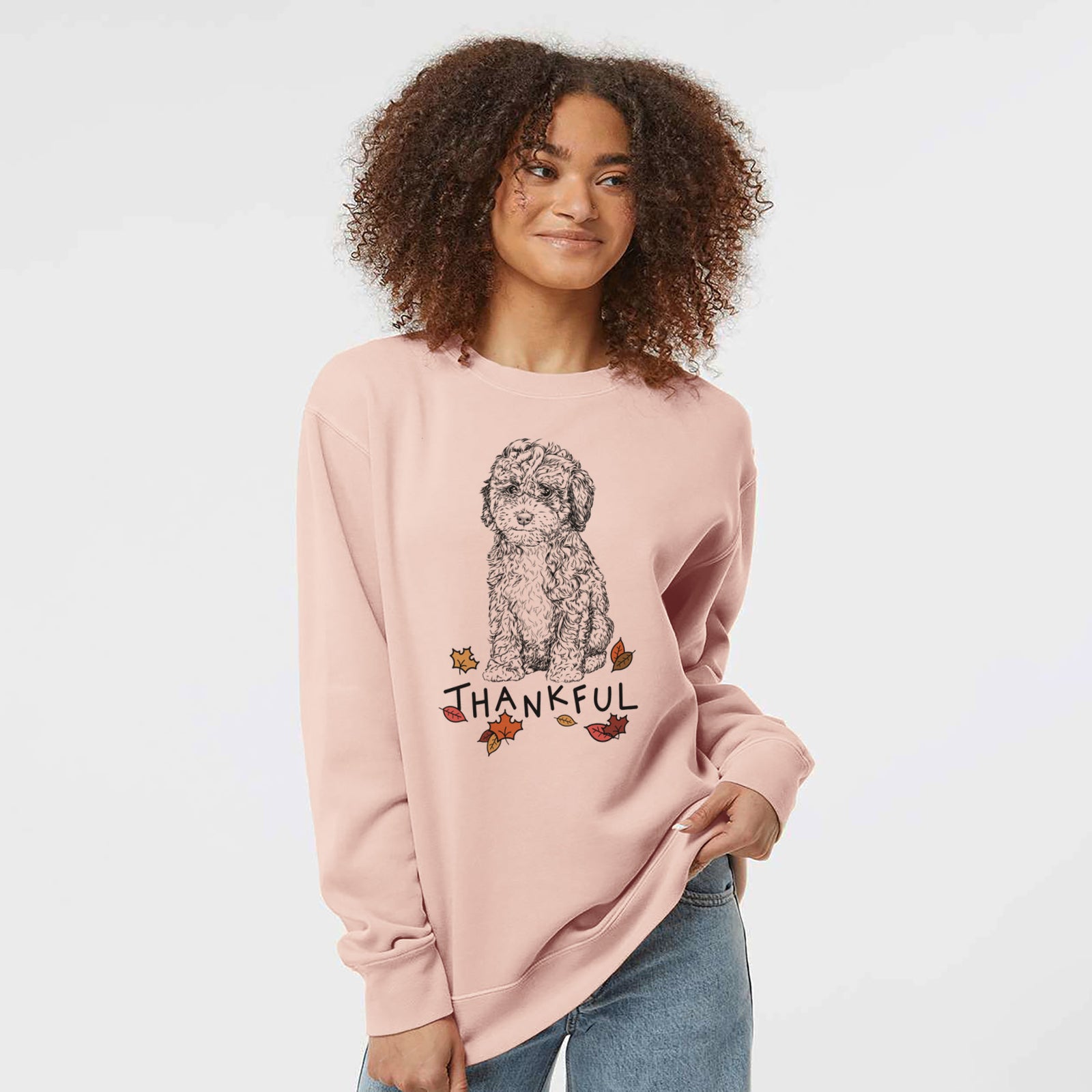 Hand-drawn sketch of Sweet Tea the Mini Doodle with 'Thankful' lettering and autumn leaves on a Dusty Pink Unisex pigment dyed crew sweatshirt