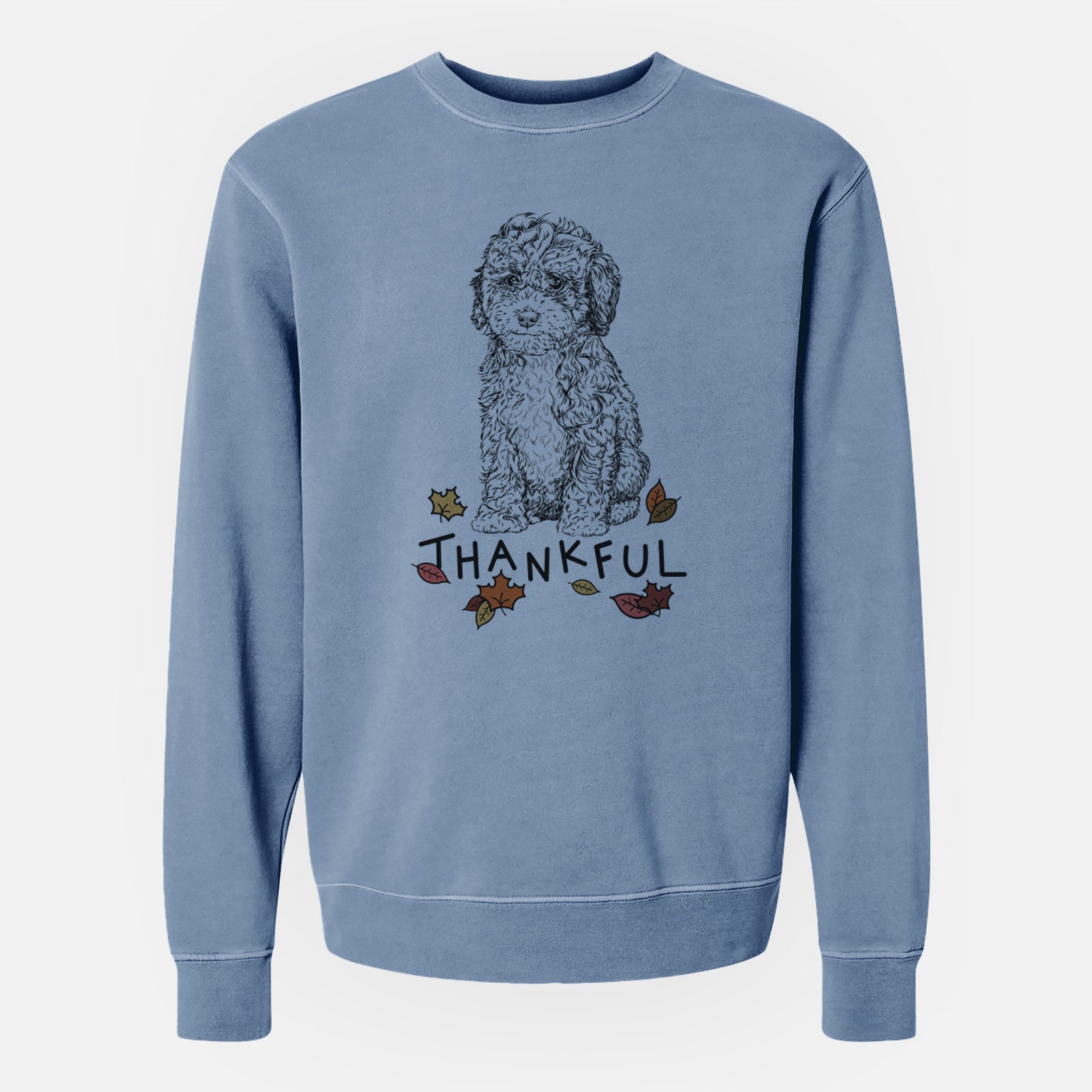Hand-drawn sketch of Sweet Tea the Mini Doodle with 'Thankful' lettering and autumn leaves on a Slate Blue Unisex pigment dyed crew sweatshirt