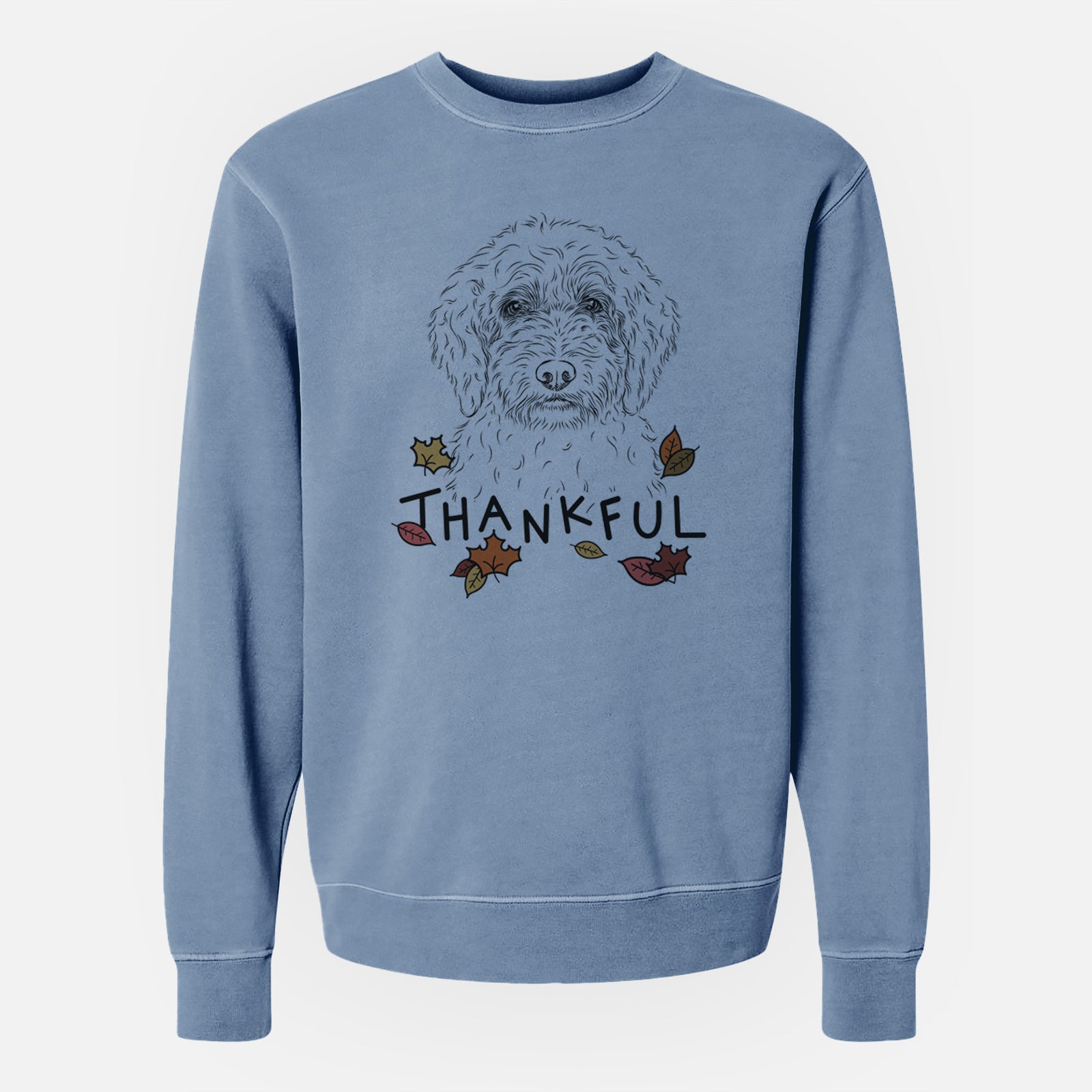 Hand-drawn sketch of Teddy the Labradoodle with 'Thankful' lettering and autumn leaves on a Slate Blue Unisex pigment dyed crew sweatshirt