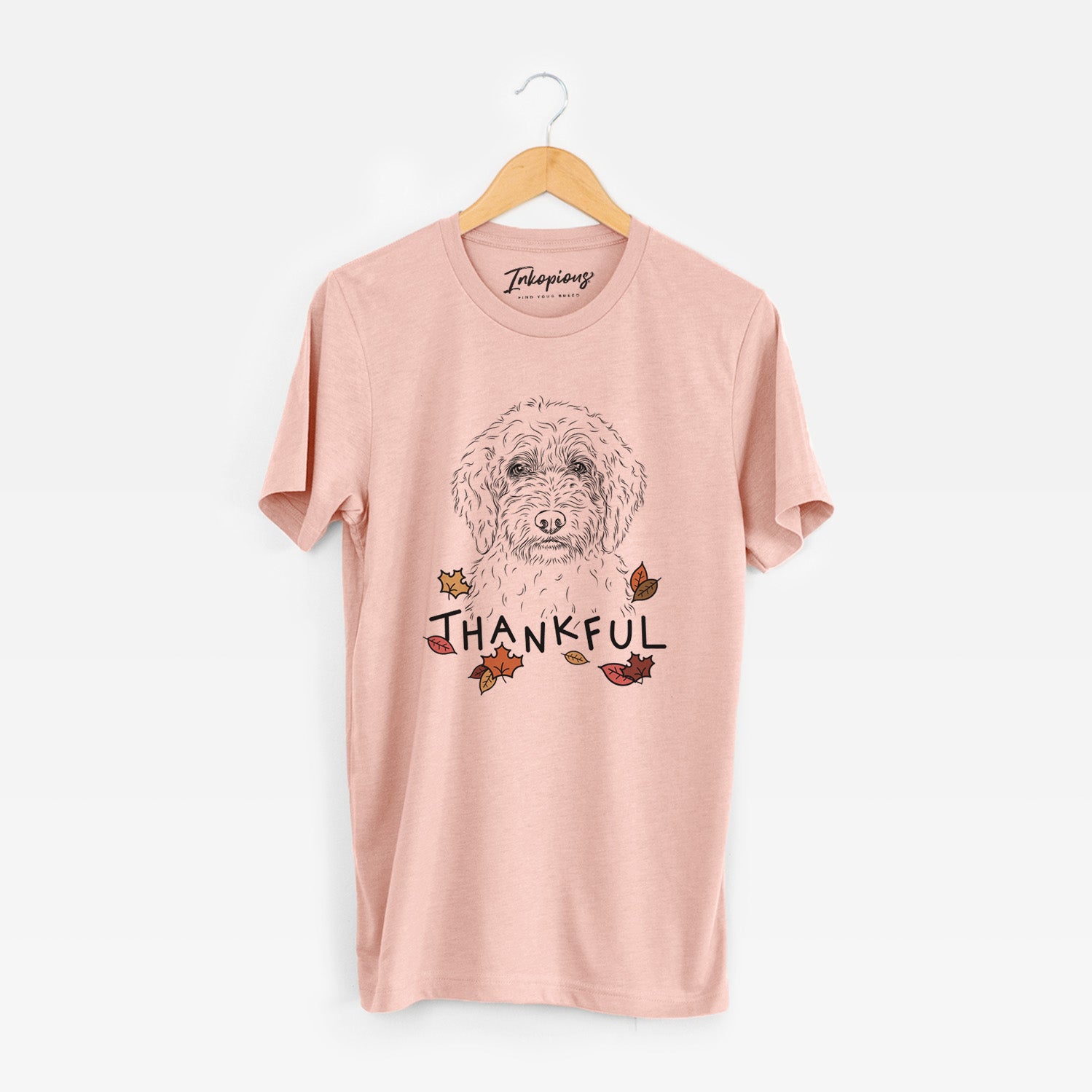 Hand-drawn sketch of Teddy the Labradoodle with 'Thankful' lettering and autumn leaves on a Peach Unisex crewneck