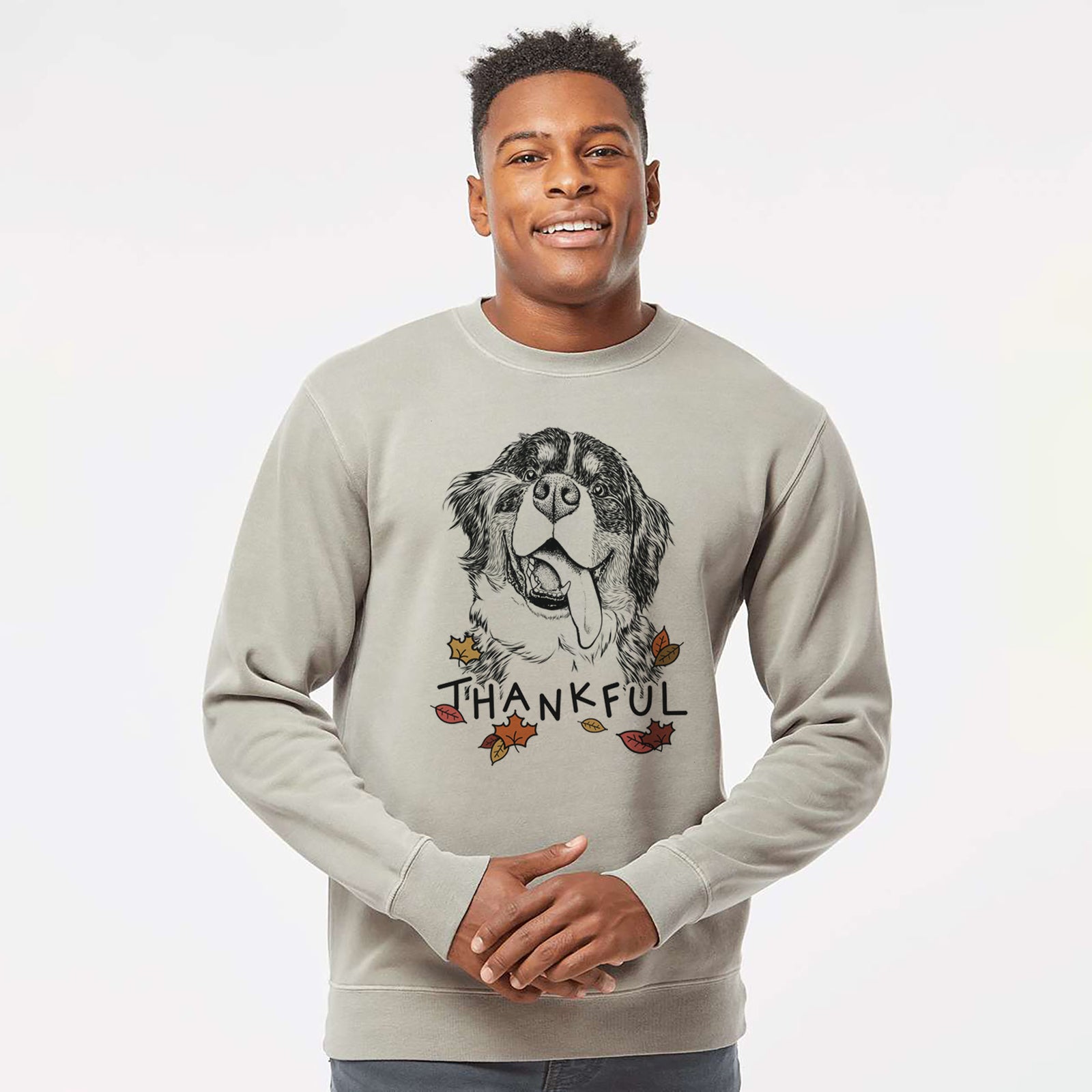 Hand-drawn sketch of Theo the Bernese Mountain Dog with 'Thankful' lettering and autumn leaves on a Cement Unisex pigment dyed crew sweatshirt