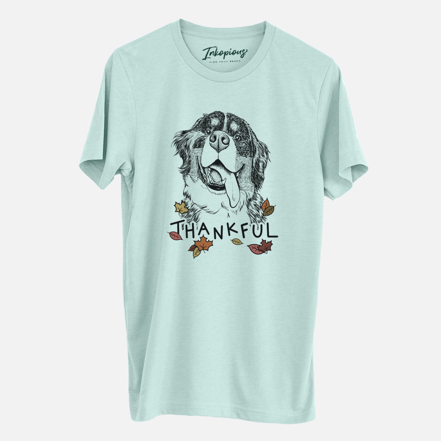 Hand-drawn sketch of Theo the Bernese Mountain Dog with 'Thankful' lettering and autumn leaves on a Heather Sage Unisex crewneck