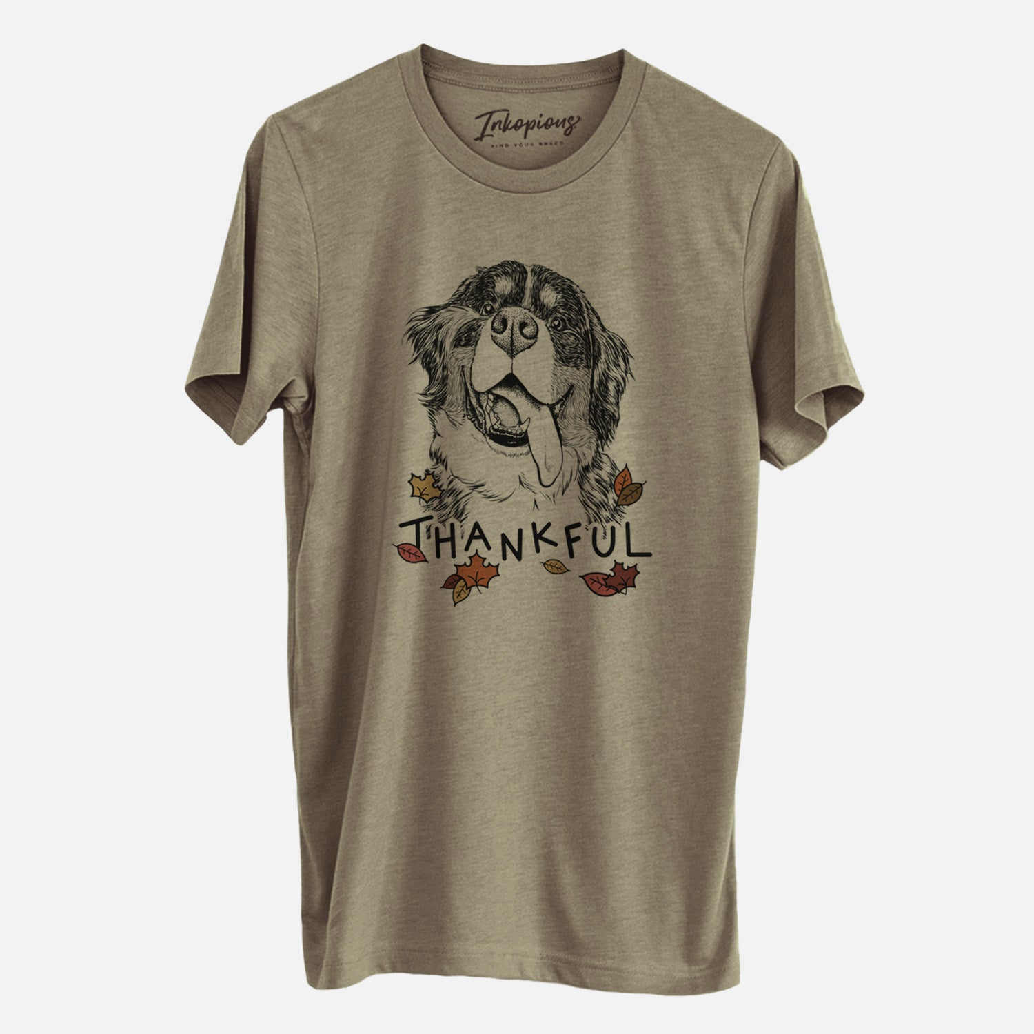 Hand-drawn sketch of Theo the Bernese Mountain Dog with 'Thankful' lettering and autumn leaves on an Olive Unisex crewneck