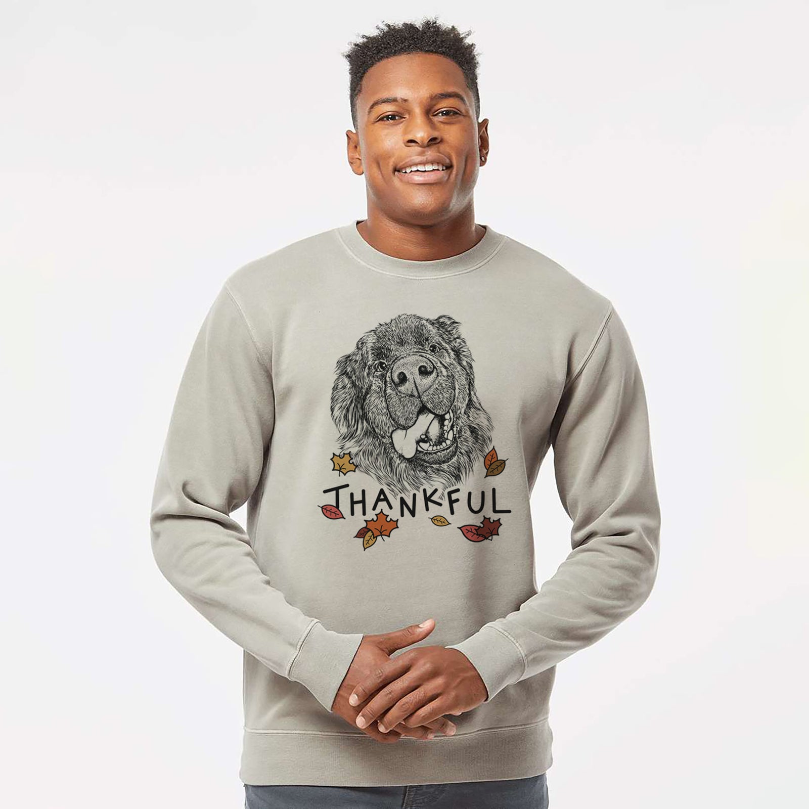 Hand-drawn sketch of Tuna the Newfoundland with 'Thankful' lettering and autumn leaves on a Cement Unisex pigment dyed crew sweatshirt