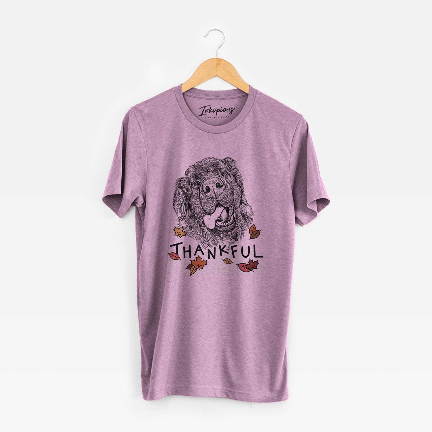 Hand-drawn sketch of Tuna the Newfoundland with 'Thankful' lettering and autumn leaves on an Orchid Unisex crewneck