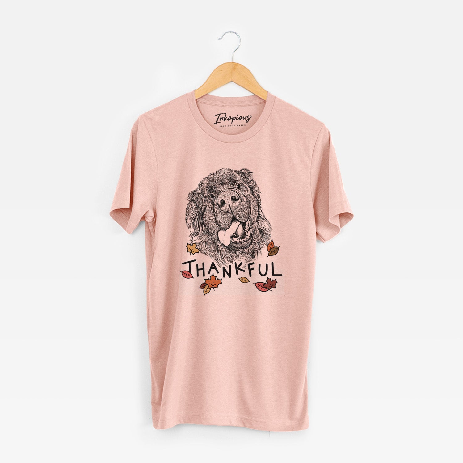Hand-drawn sketch of Tuna the Newfoundland with 'Thankful' lettering and autumn leaves on a Peach Unisex crewneck