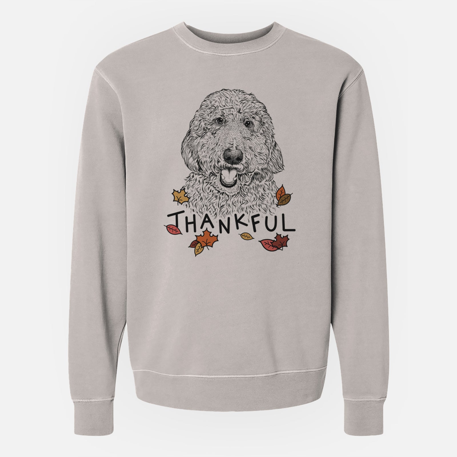 Hand-drawn sketch of Whisper the Goldendoodle with 'Thankful' lettering and autumn leaves on a Cement Unisex pigment dyed crew sweatshirt