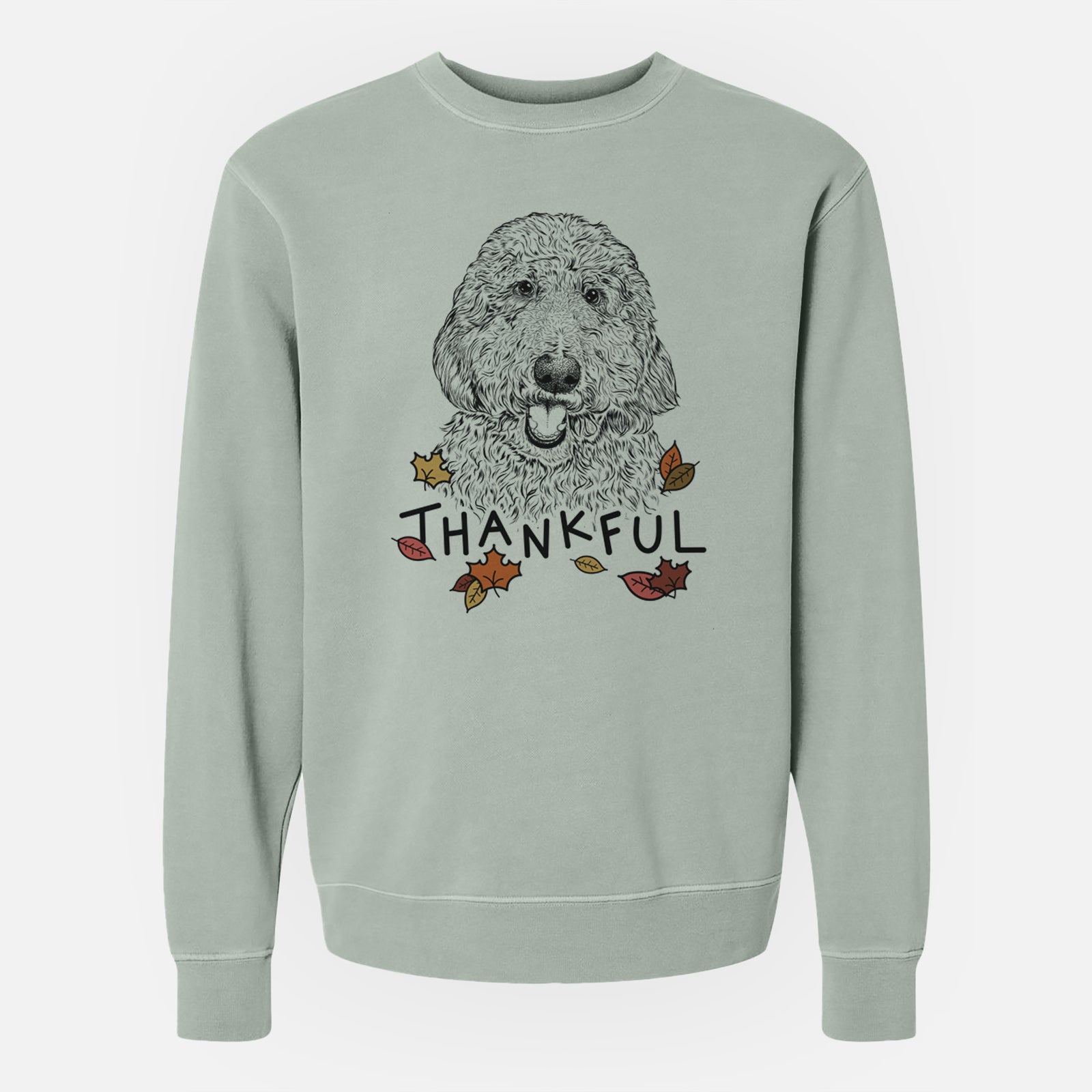 Hand-drawn sketch of Whisper the Goldendoodle with 'Thankful' lettering and autumn leaves on a Sage Unisex pigment dyed crew sweatshirt