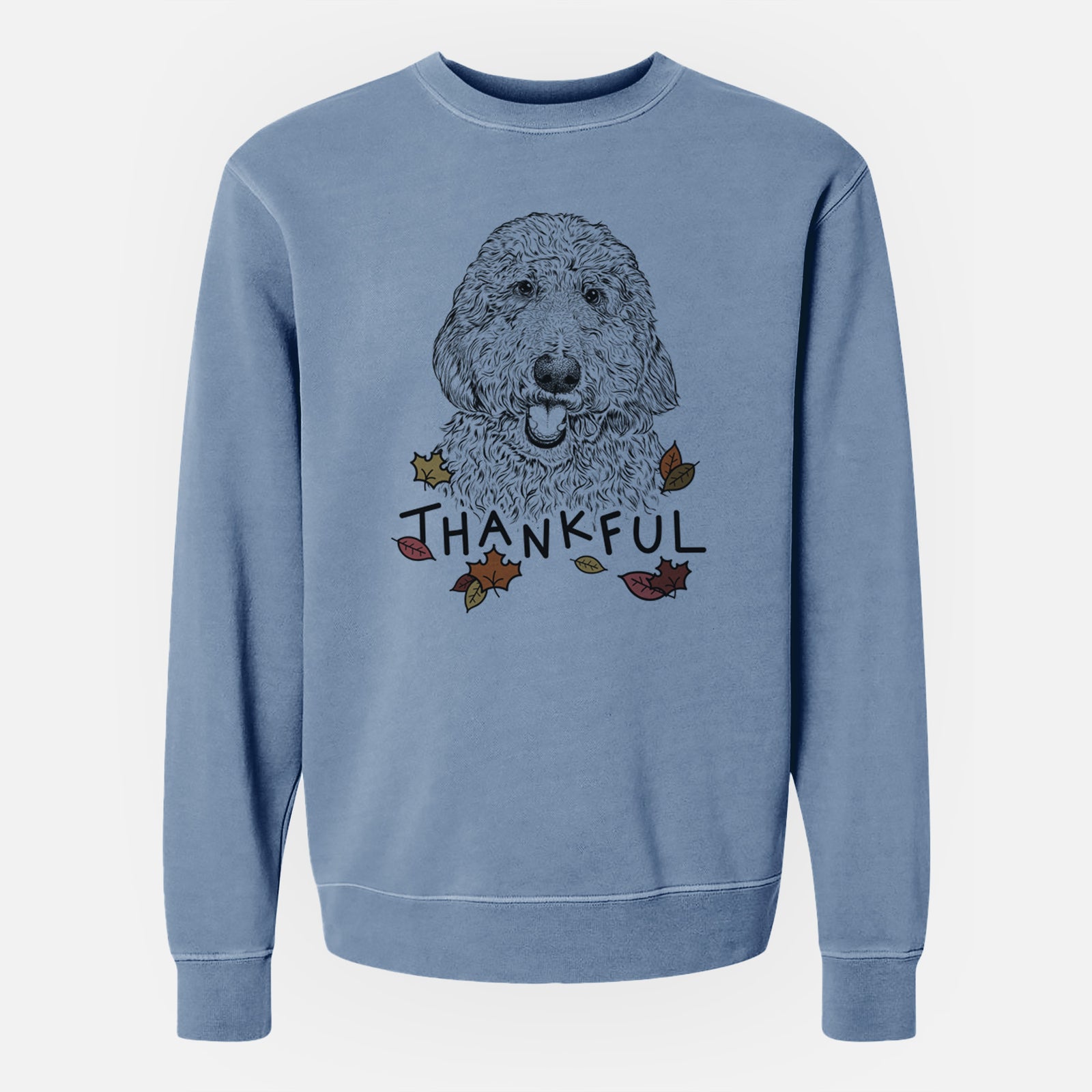 Hand-drawn sketch of Whisper the Goldendoodle with 'Thankful' lettering and autumn leaves on a Slate Blue Unisex pigment dyed crew sweatshirt