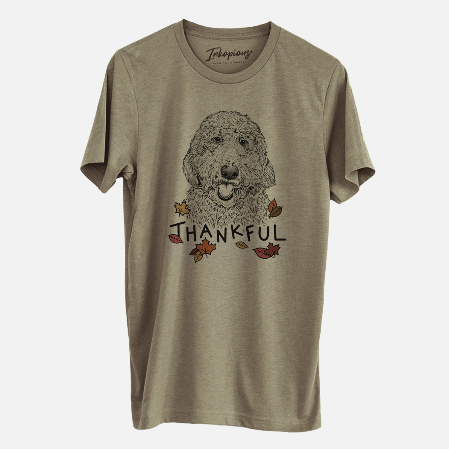 Hand-drawn sketch of Whisper the Goldendoodle with 'Thankful' lettering and autumn leaves on an Olive Unisex crewneck