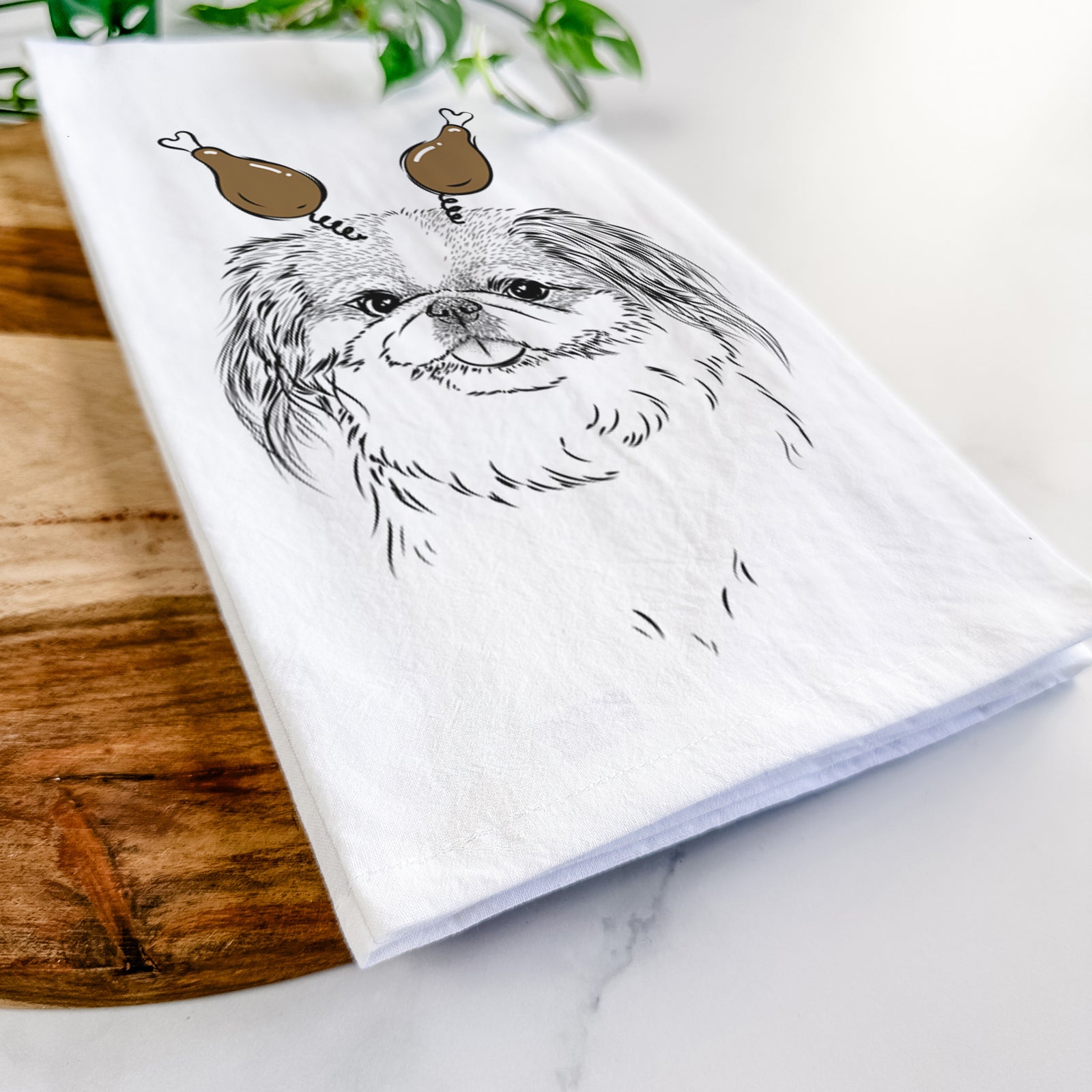 Hand-drawn sketch of Abra Bean the Pekingese with a Thanksgiving turkey headpiece on a tea towel