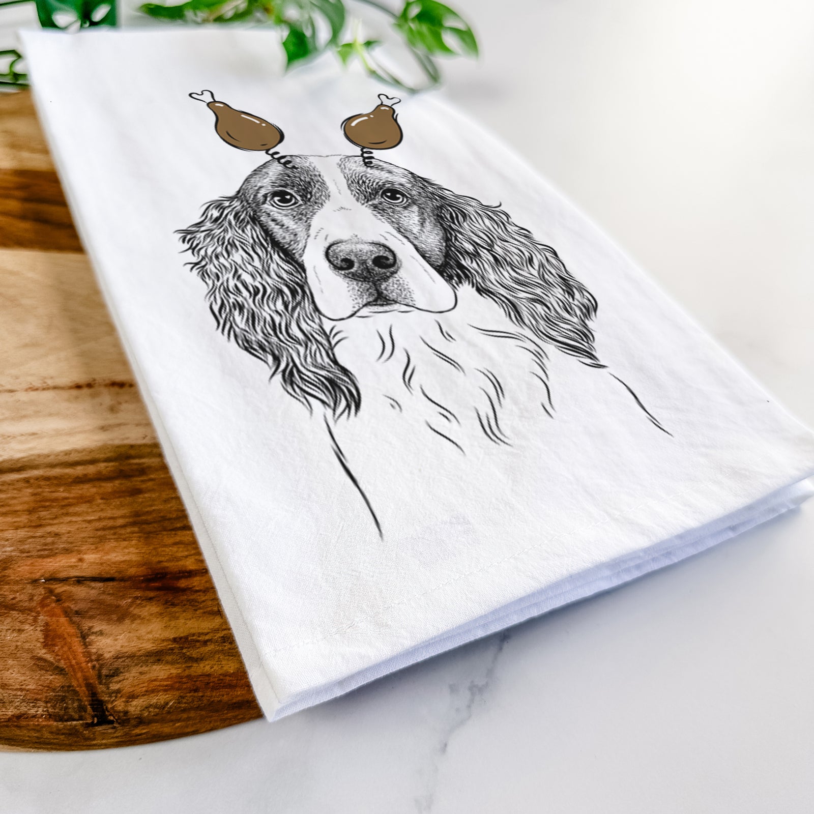 Hand-drawn sketch of Annie the English Springer Spaniel with a Thanksgiving turkey headpiece on a tea towel